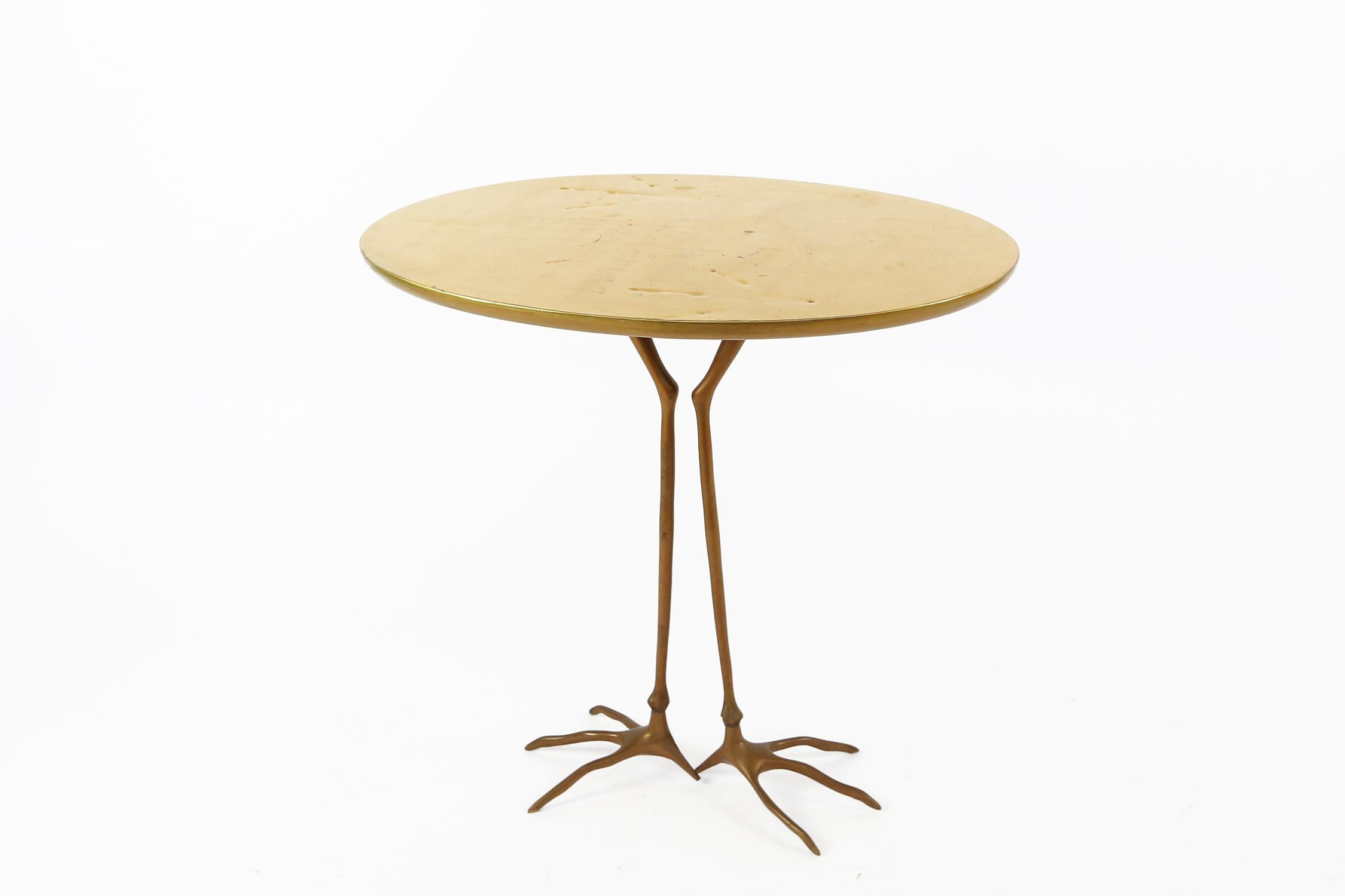 This early side table by surrealist artist Méret Oppenheim is part of the 1972 serial production of the original design she made in 1939. Both the golden color and shape of this table are very distinctive. The table is can be seen as the abstract