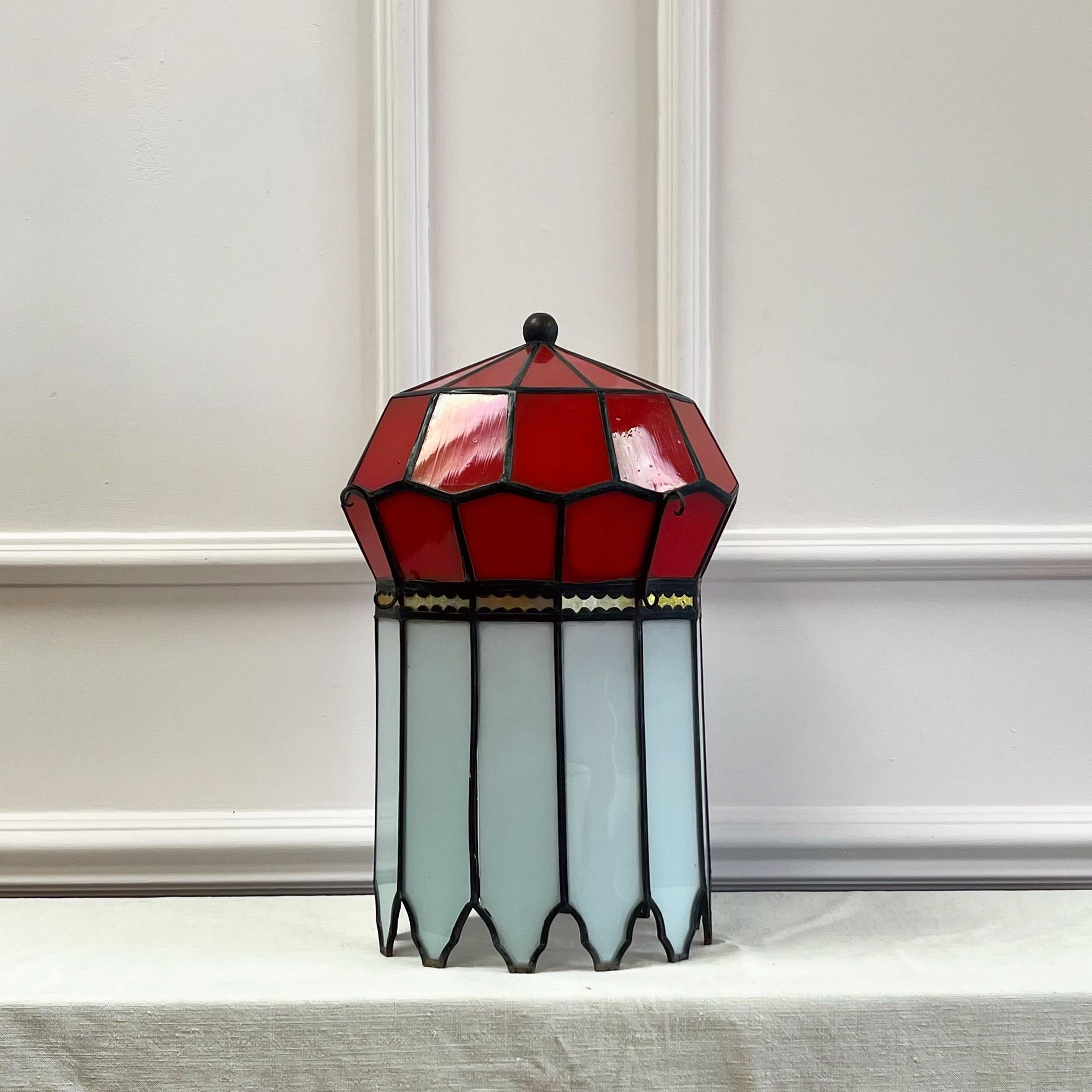An exceptionally unusual and rare chinoiserie glass lantern, the compressed dodecagon form reminiscent of imperial tents - the top with red glass panels separated by a strip of reverse gilded mirrors terminating in stylised white glass