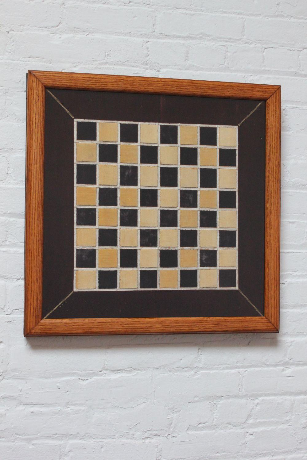 Unique Folk Art chess / checker board composed of a handmade, burgundy velvet quilt with beige, white and gold stitched accents, all housed within a glass-fronted oak frame (ca. 1910-1920, USA).
There are scuffs present to the glass, as shown;