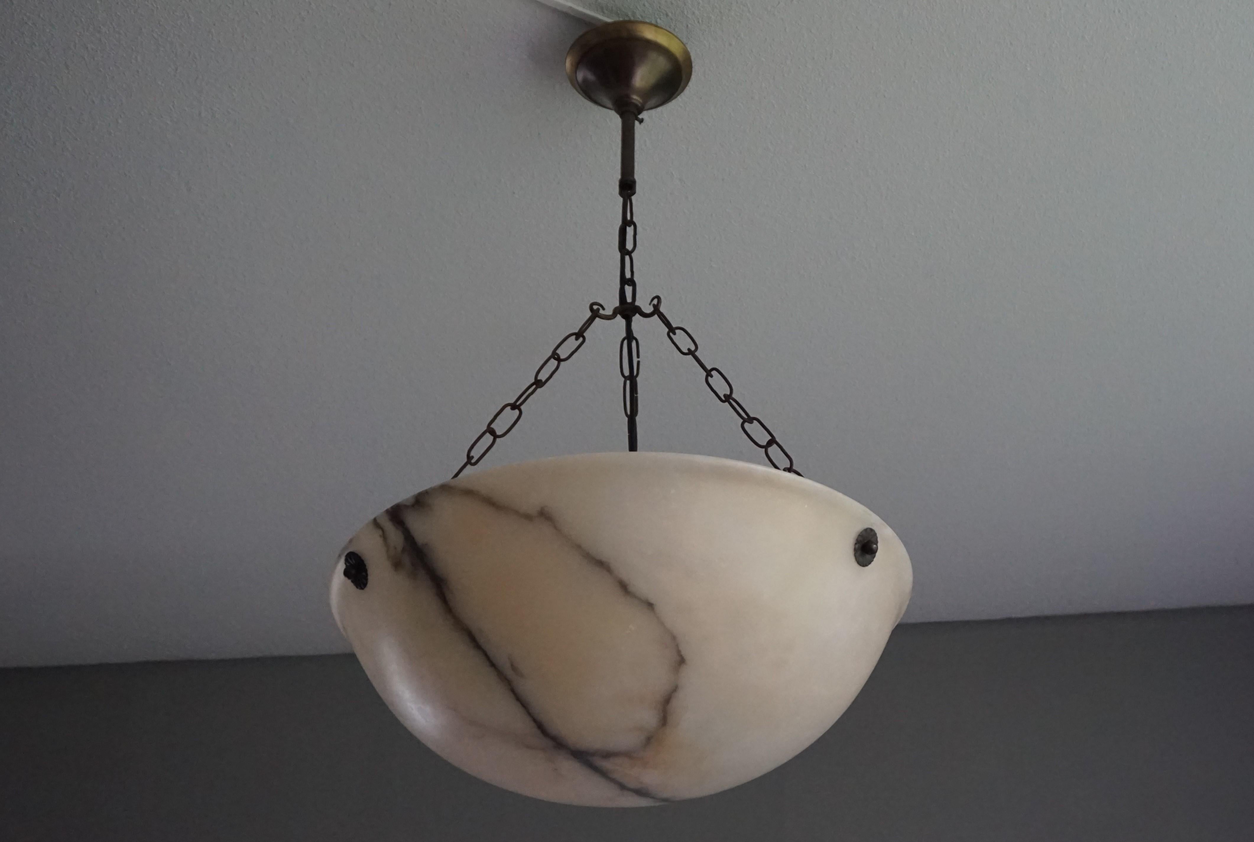 Antique and striking alabaster pendant.

This antique alabaster chandelier is of great quality and condition. The striking alabaster dish/bowl with its large diameter and unusual height has a lightning-like black vein running through the middle.