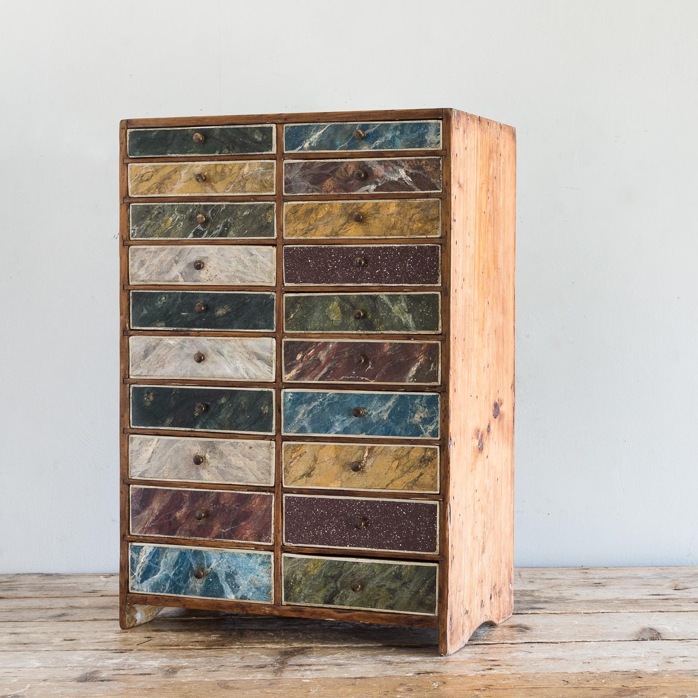 Early 20th century marble and grainer's sampler cabinet, the twenty graduated drawers with later paintwork.