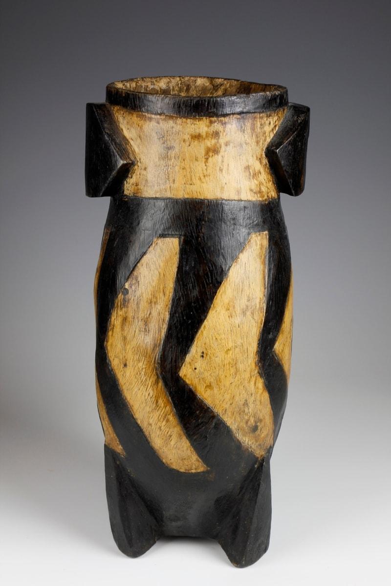 This fine early twentieth-century milk pail - known as an 'ithunga' - comes from the Zulu culture in South Africa. The milk pail displays a striking two-toned appearance, in which a darker-coloured geometric diagonal pattern and scorched areas -