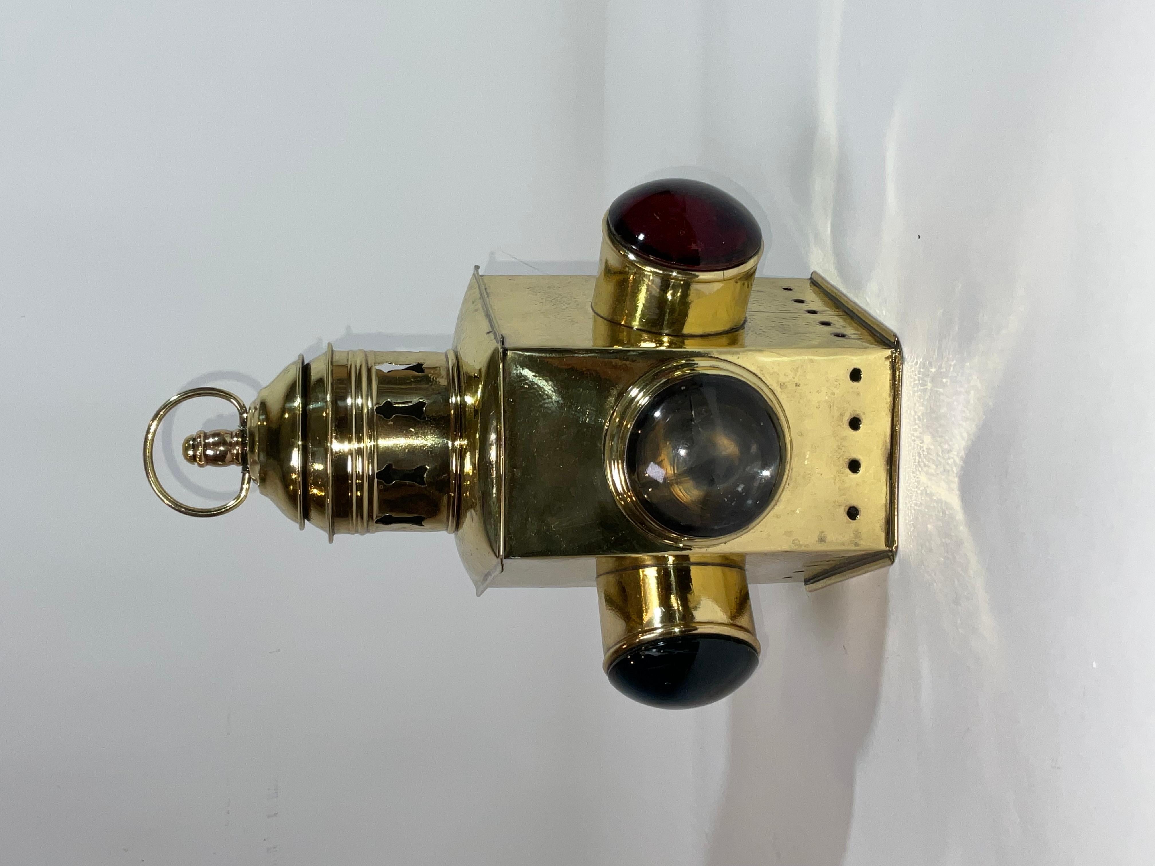 Antique ships lantern with three bulleye lenses red, blue, and clear. The lantern hughly polished and lacquered. There is a vented turret with carry ring. No burner inside. Choice maritime relic.

Weight:    2 lbs.
Overall Dimensions:    10