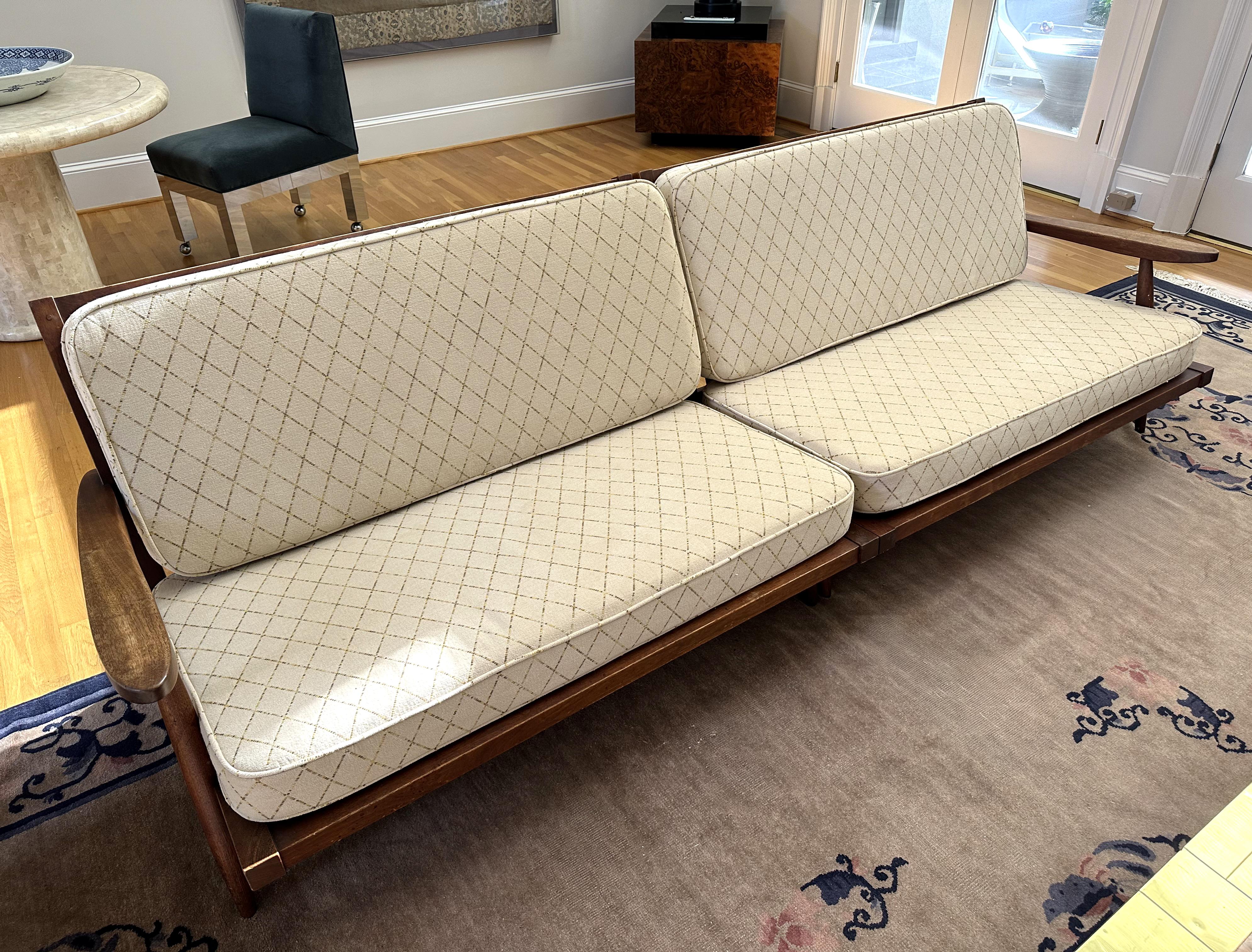 Two single arm walnut settee in a rare sectional configuration, custom-made and gifted to a family friend, circa 1950s by George Nakashima in his New Hope Studio. The two settees can be used as an opposing pair, a L-shape configuration or a very
