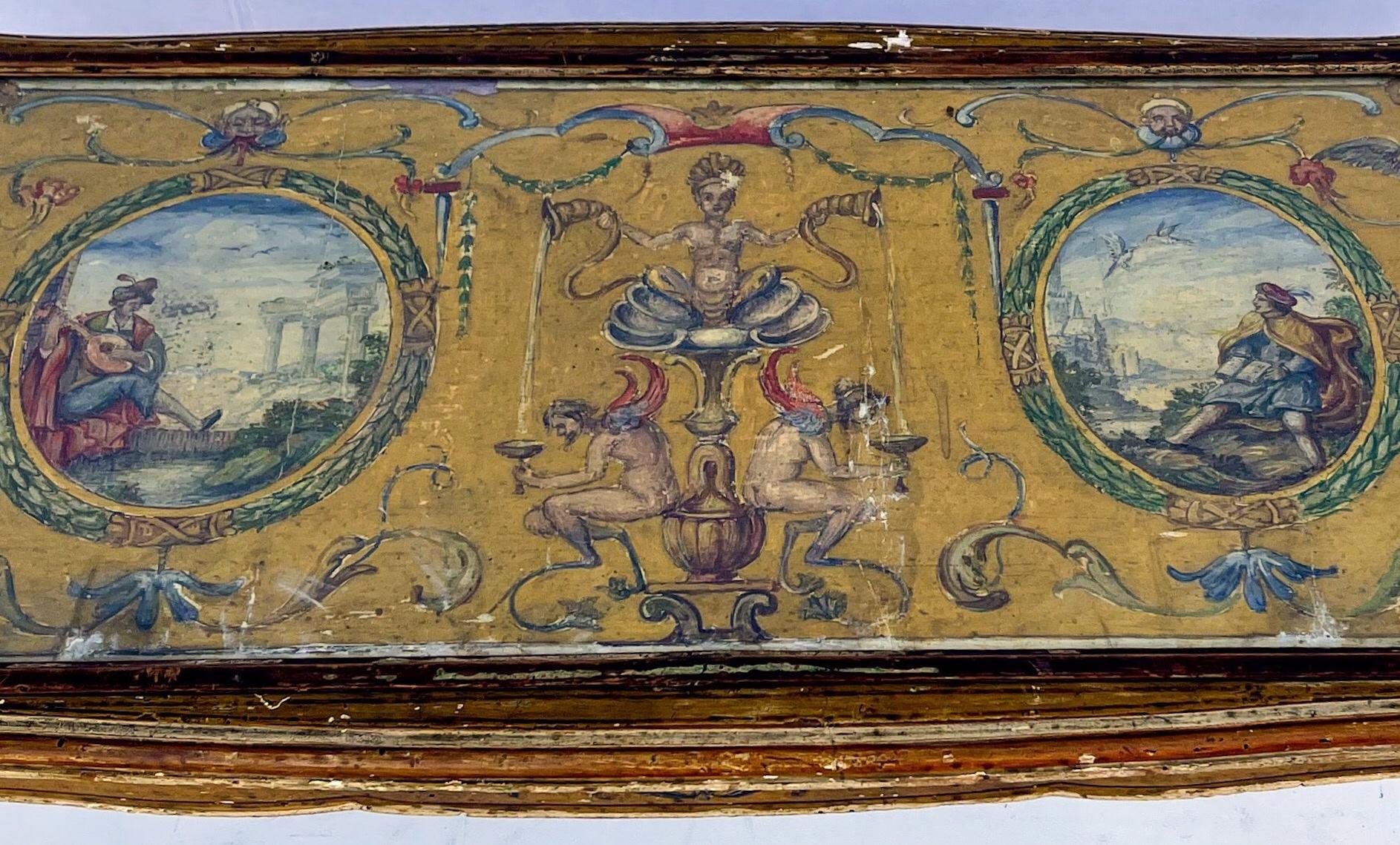 This is amazing! It is an early 20th century Venetian coffee table with wonderful hand painted greco-Roman scences. The top is safely protected under glass. The piece does have some age appropriate patina. It is marked on the underside.