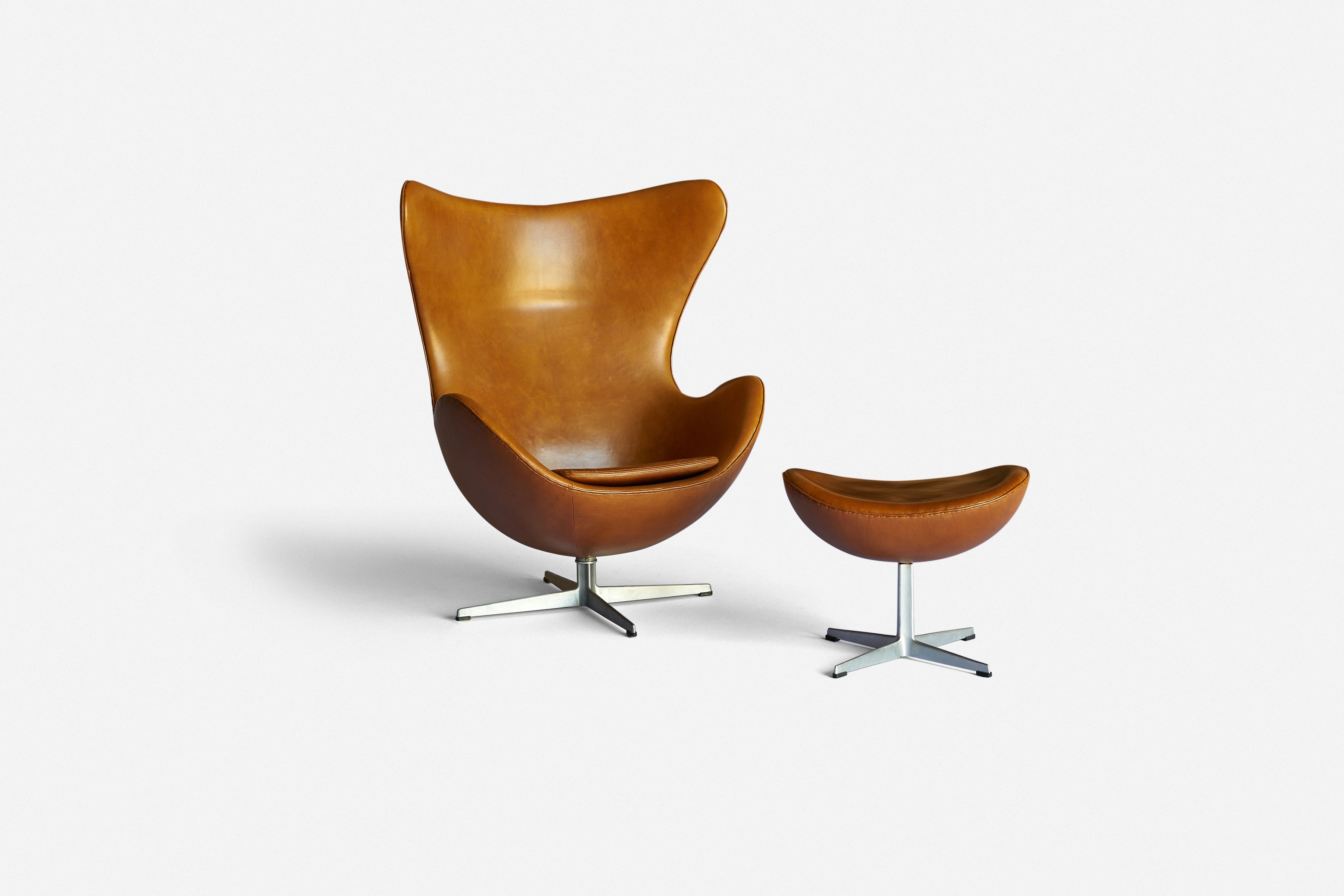 Arne Jacobsen
Chair and ottoman
Fritz Hansen
Denmark, 1958
Leather, cast aluminum, plastic
34 d x 32 d x 42 h inches

Foil label to base.