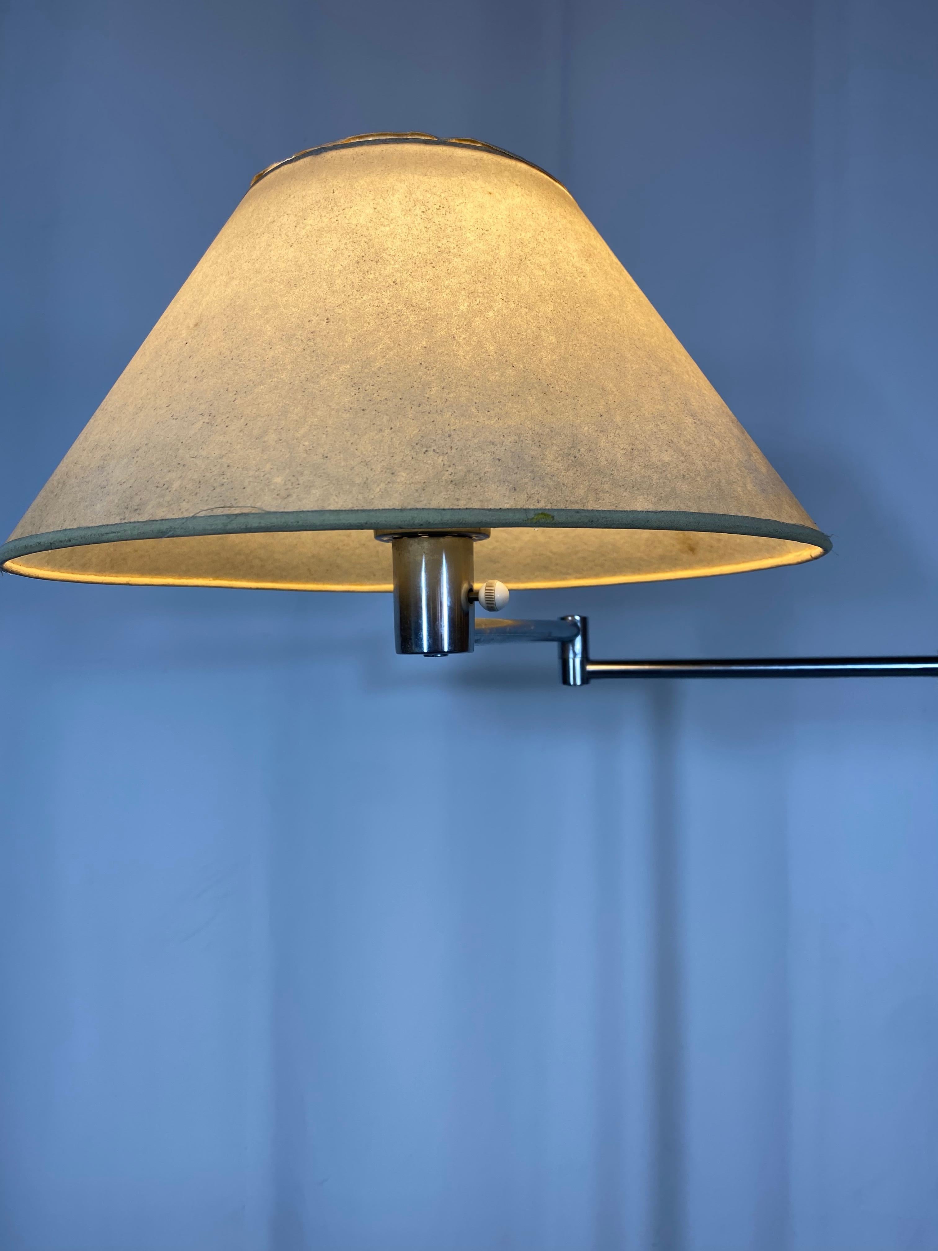One of the purest examples I have ever owned..Early and rare version of the now iconic Machine Age Nessen swing arm floor lamp. This lamp retains its (always replaced) glass shade as well as its original parchment shade,,NOTE^ the original early