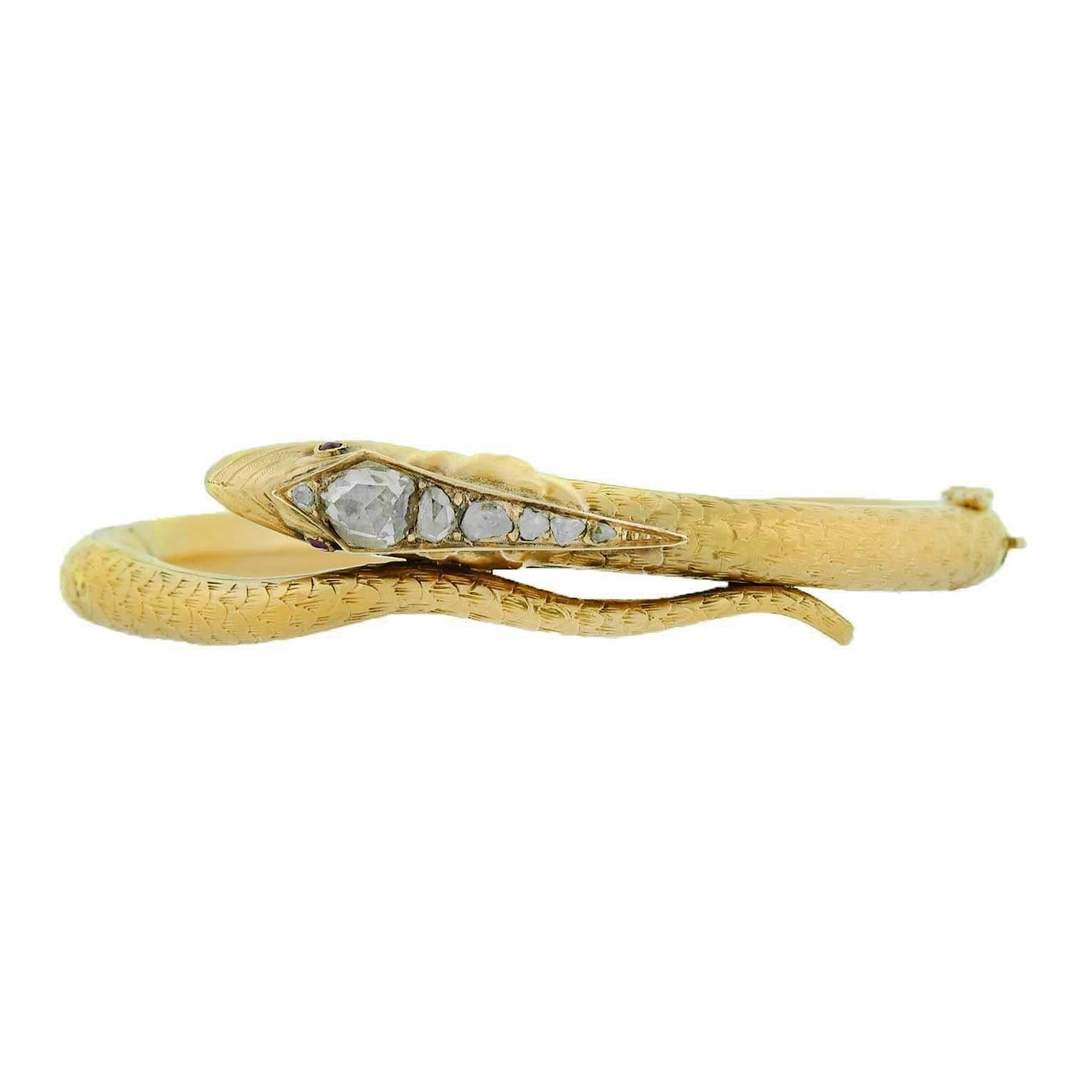 An absolutely stunning and unique diamond snake bracelet from the Early Victorian (ca1814-1865) era! Crafted in 18kt yellow gold, this fantastic bangle portrays a snake whose body curls around the wrist, with its head and tail overlapping at the