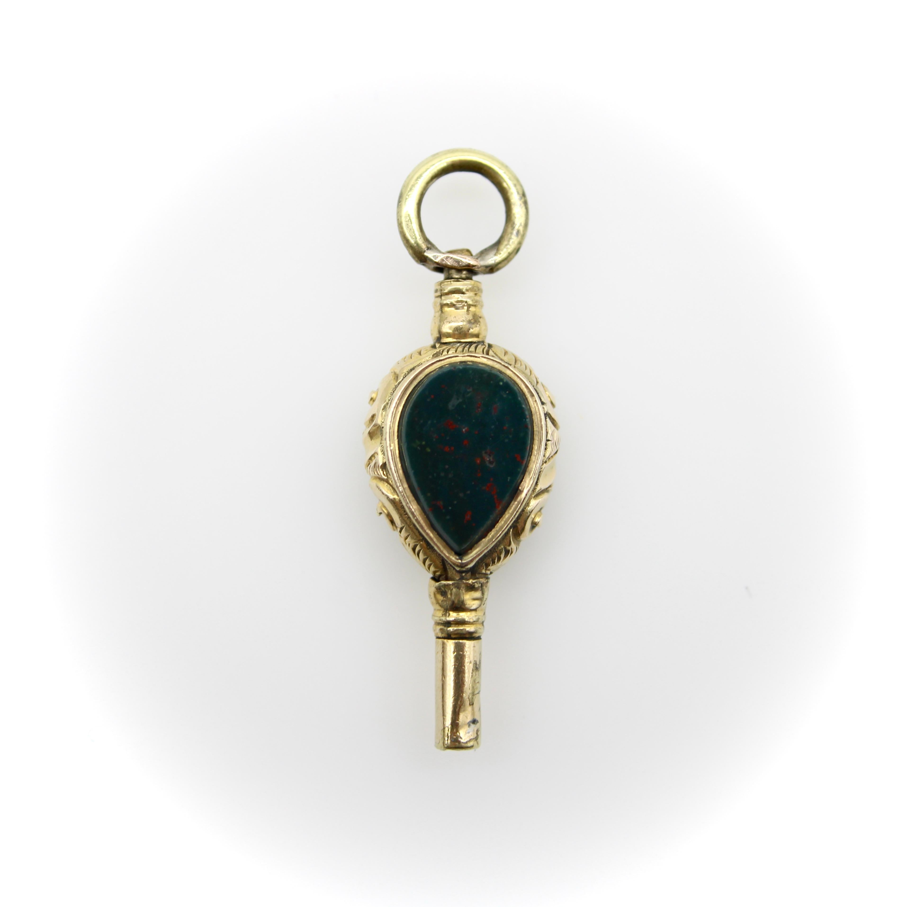 Circa 1840, this watch key fob features a tear drop shaped bloodstone on one side and a rock crystal on the other. The bloodstone is a beautiful flat stone with flecks of red throughout; the rock crystal is faceted so that you can see into the fob.