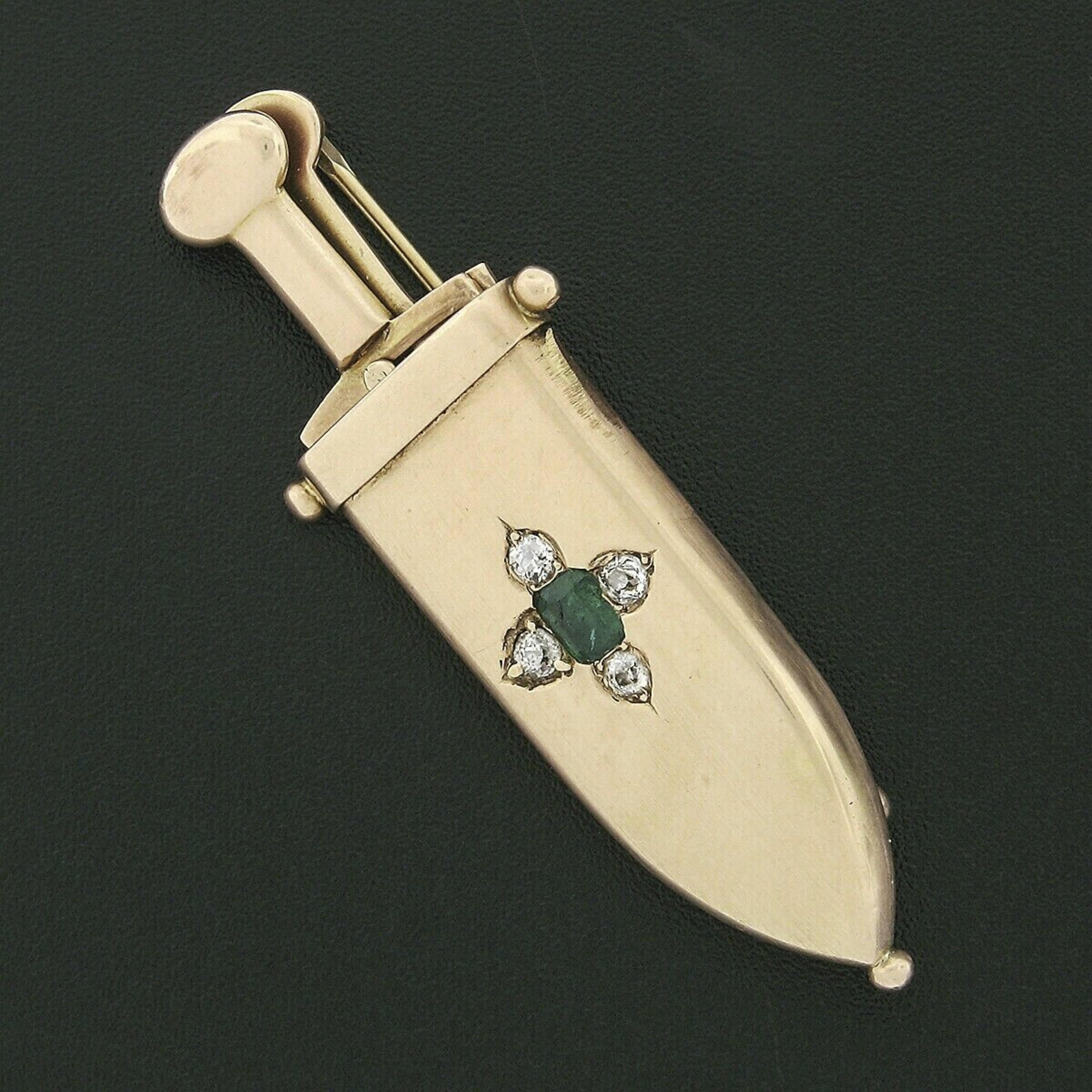 Here we have a gorgeous antique sword and sheath brooch crafted from solid 14k yellow gold with a rich rosy tone during the early Victorian era. This brooch features an emerald cut natural emerald weighing approximately 1/4 carat and displaying a