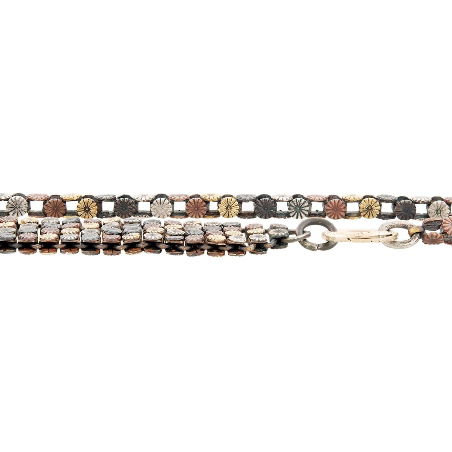 Shakudo is the use of mixed metal alloys and was originally used in Japanese armor and swords. Artisans would sometimes remove the Shakudo plaques from the armor and incorporate them into jewelry or art. It has become very collectible and quite