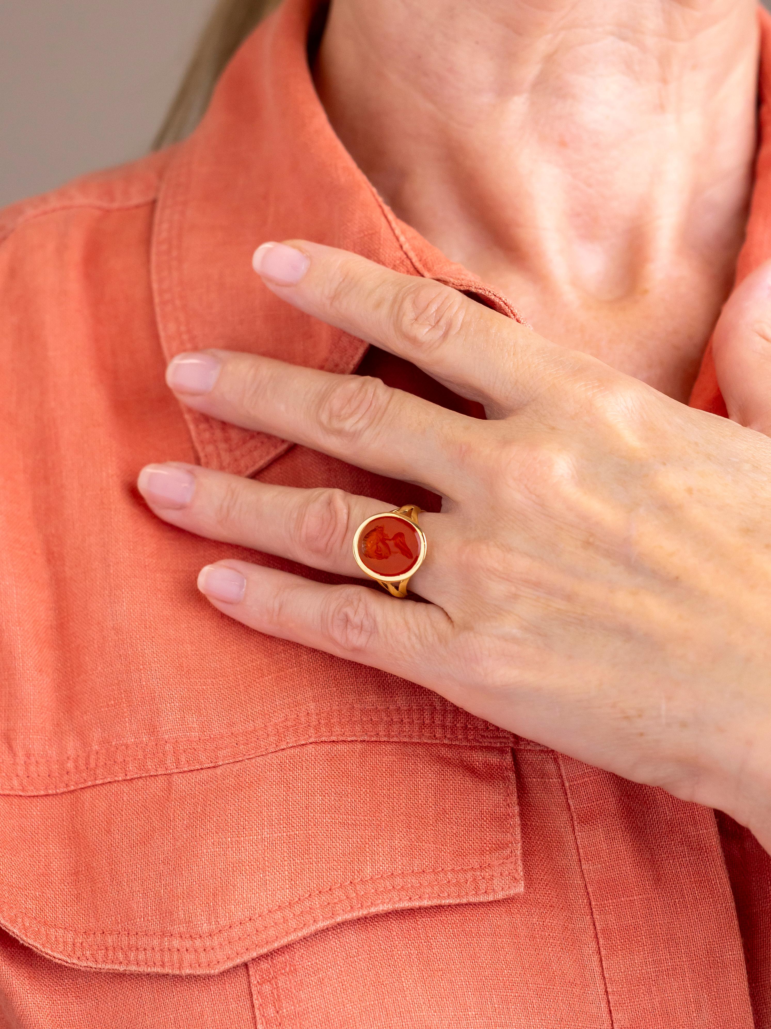 This charming 18 karat gold ring has been set with an oval carnelian intaglio featuring the bust of a lady. The ring and intaglio which date to circa 1835 could be described as late Georgian or early Victorian in their age and whilst probably