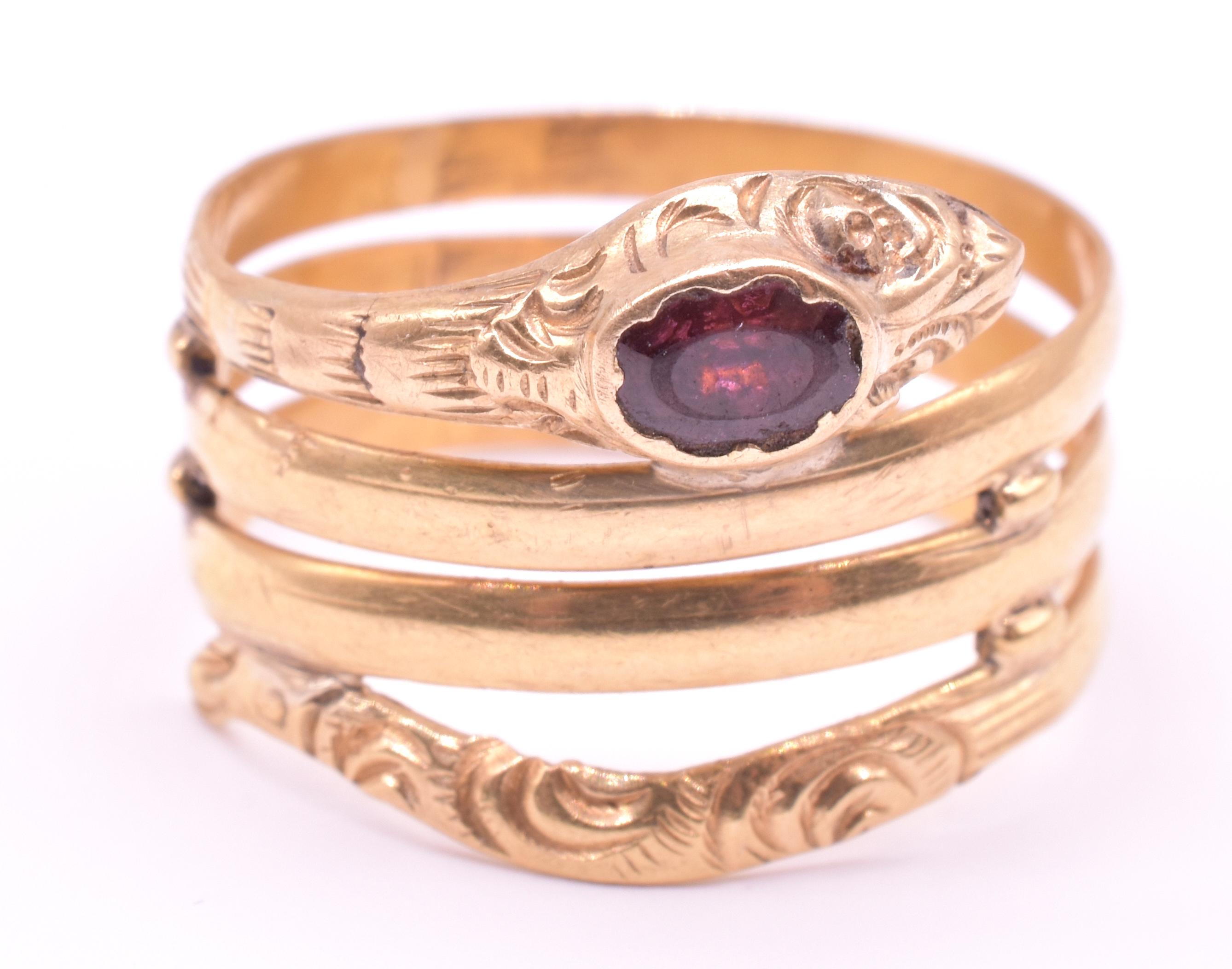 Beautifully engraved wide 18K gold snake ring with a garnet topped head makes a wonderful statement. Snake rings represent eternal love.  They became popular in England after Queen Victoria received one as her engagement ring.   This snake ring,  