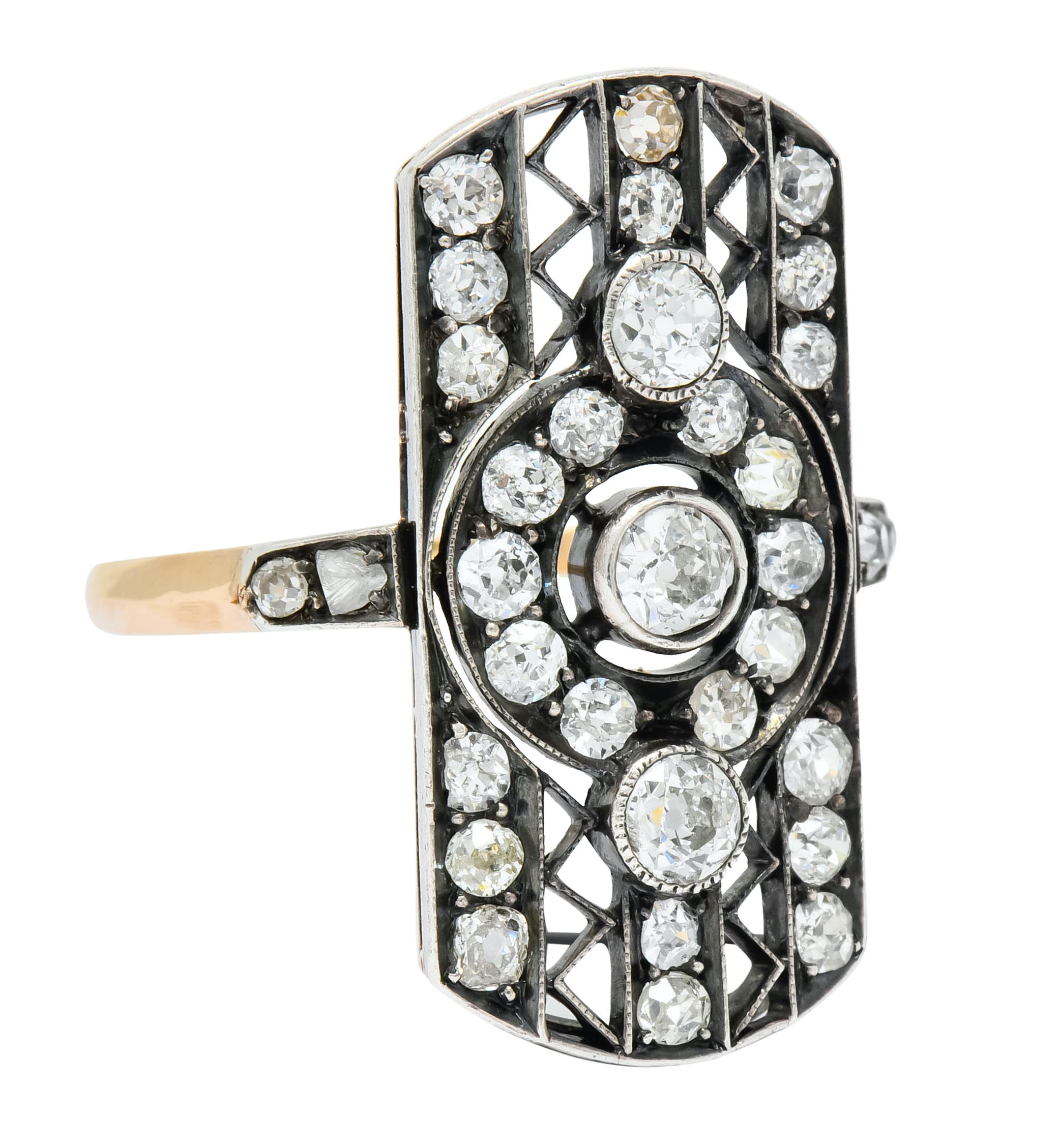 Dinner style ring designed as central circle flanked by pierced stripes featuring a zig zag motif

Centering three old mine cut diamonds, bezel set North to South, weighing approximately 0.50 carat, H/I color and VS to SI clarity

Surrounded by bead