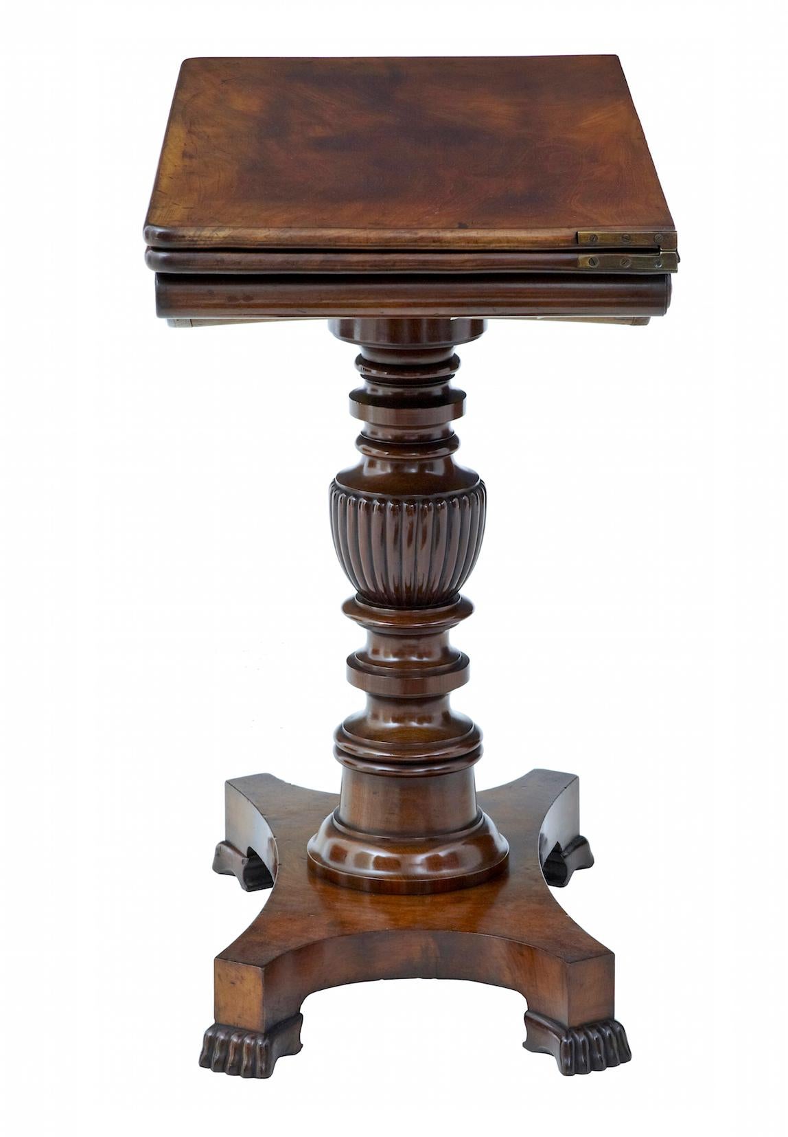 Early victorian 19th century mahogany games table circa 1840.

Fine quality carved mahogany flip top tea table. Solid mahogany top with superb colour and figuring, this flips over and twists to form a large usable surface. Below which a carved