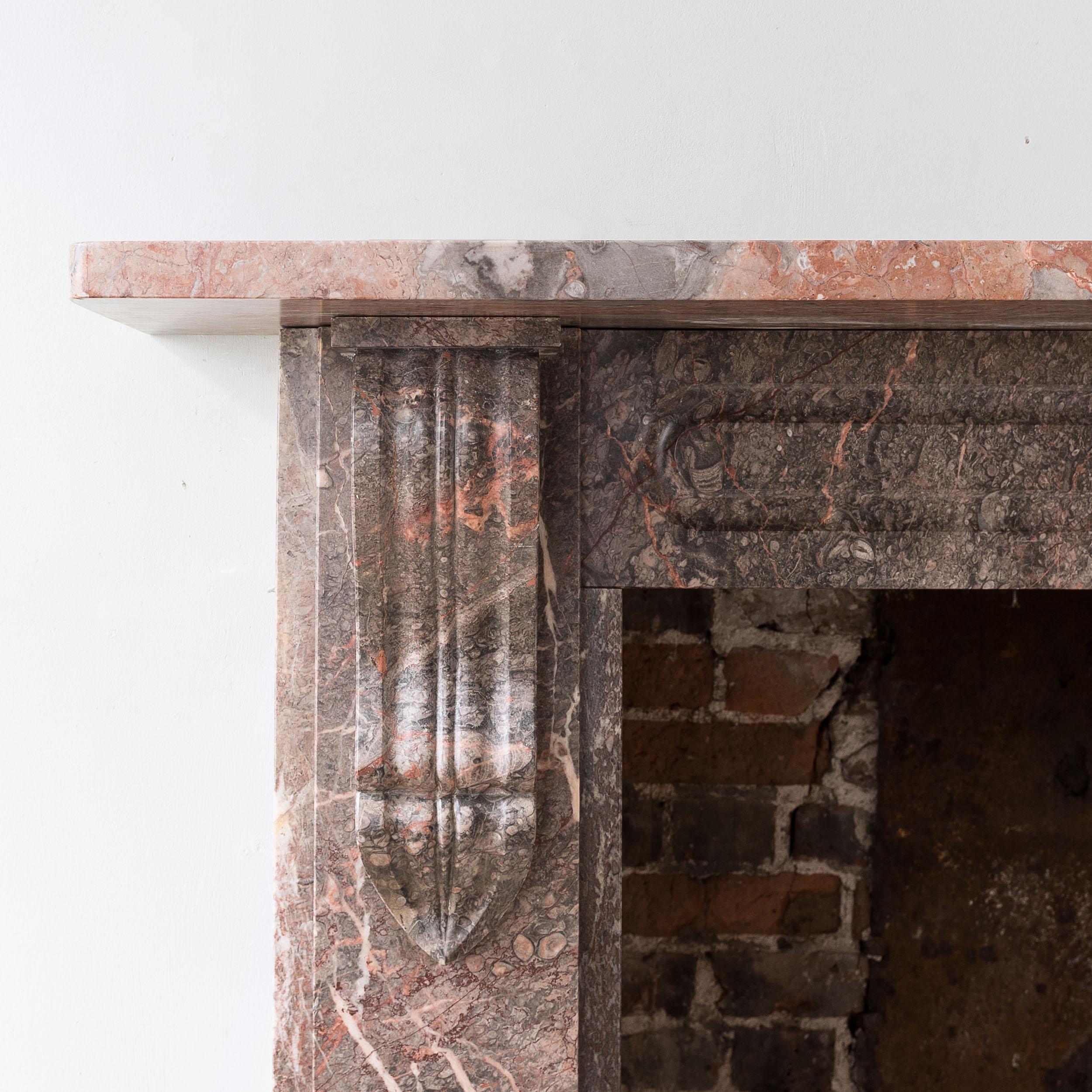 Early Victorian Ashburton marble fireplace, c.1840, with elongated corbels supporting the plain shelf, the frieze with channel-mould.

Opening width 90.5 cm x 96 cm high, Outside jamb to jamb 135 cm