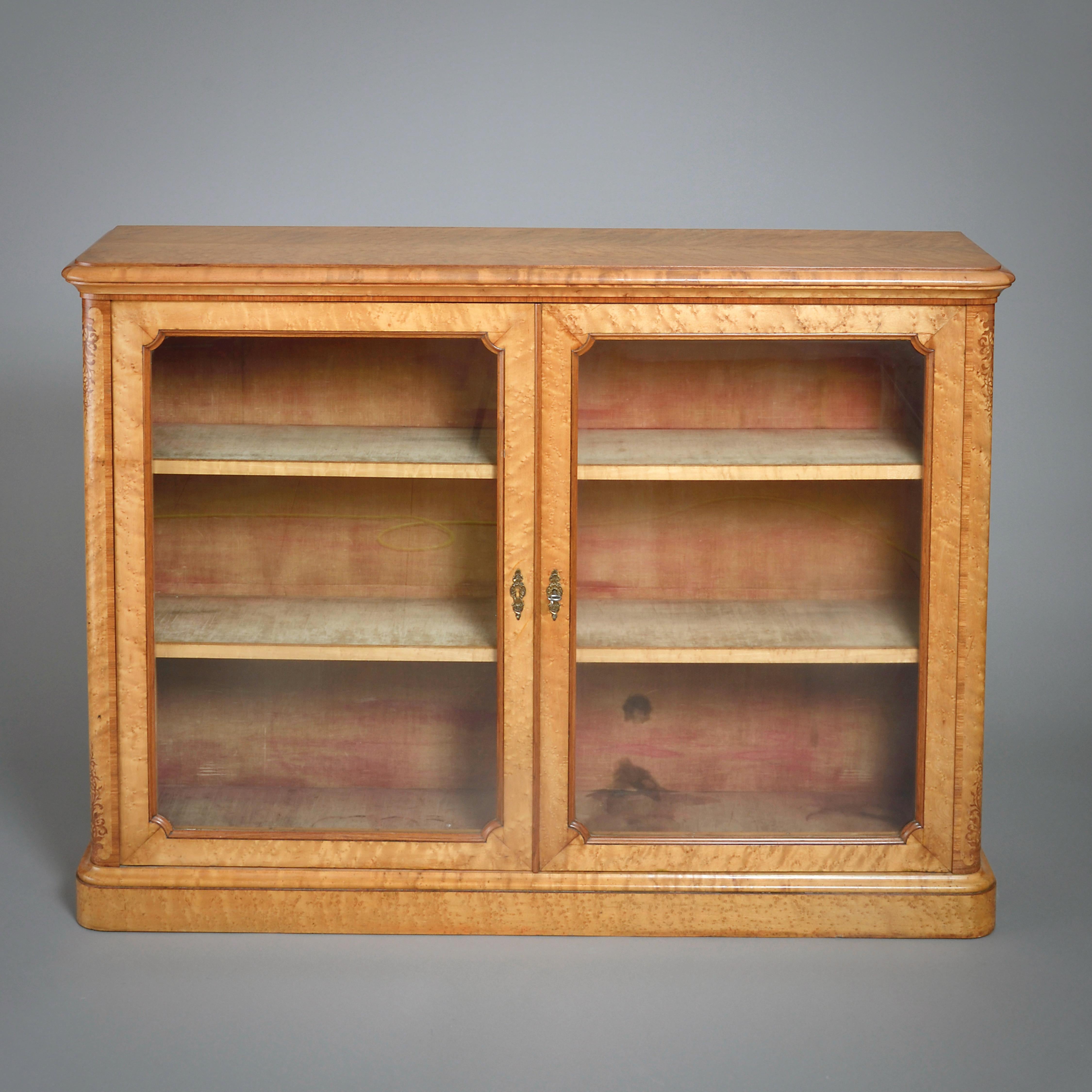 A FINE EARLY VICTORIAN BIRDS-EYE MAPLE AND AMARANTH INLAID SIDE CABINET, CIRCA 1850.

The interior with its original dusty pink velvet lining. The finely chased ormolu escutcheons also original.

Labelled Ivry Patamau from Queen Mary,