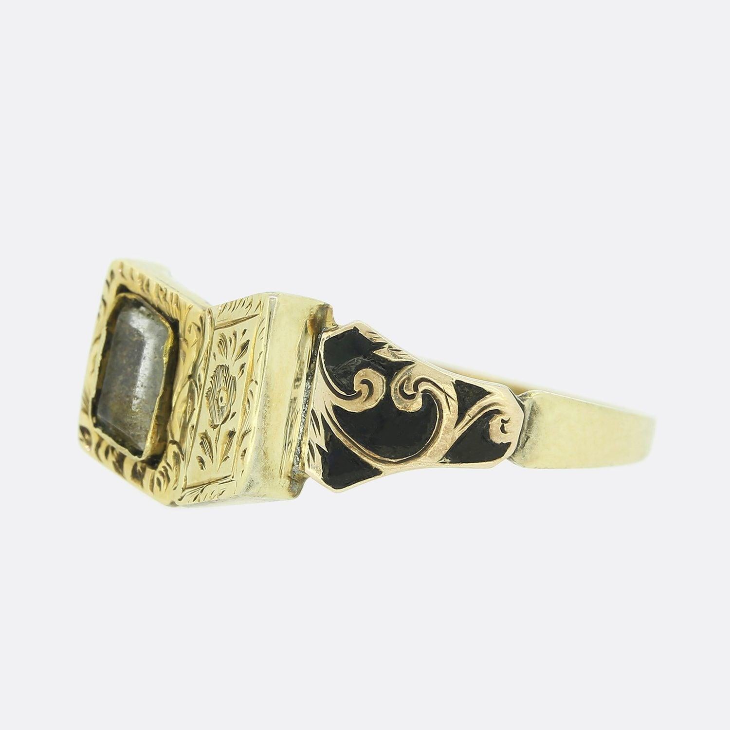 This is a wonderful 15ct yellow gold mourning ring from the Victorian era. The ring has been set with a central rectangular window in a book motif that features a small locket of hair with beautiful engraved detailing. The shoulders of the ring are