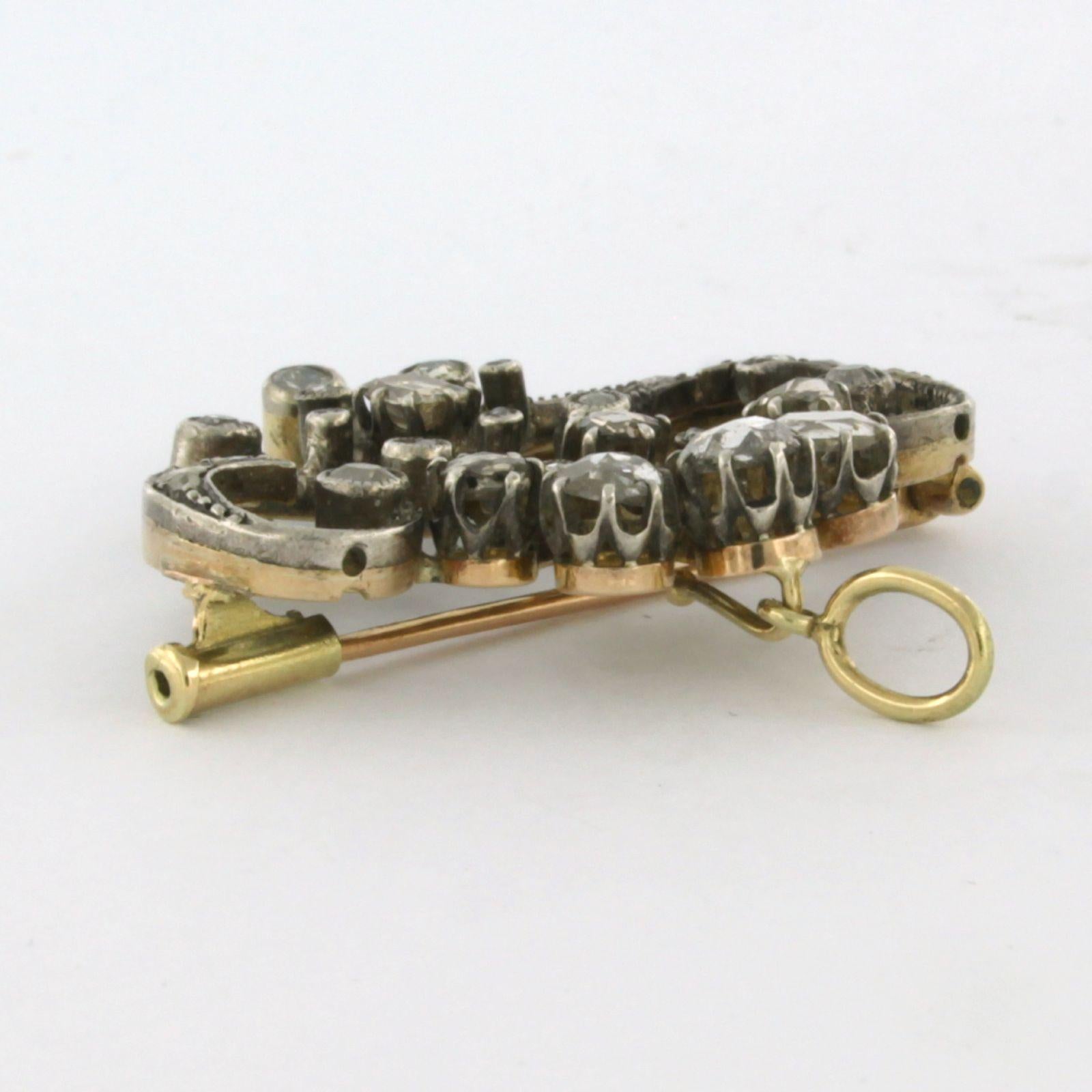 14k yellow gold with silver brooch set with old mine cut and rose diamonds up to 1.20ct – G/H – SI

Detailed description

the size of the brooch is 3.7 cm wide by 3.7 cm high

weight 9.8 grams

set with

- 6 x 2.7 mm - 4.1 mm old mine cut polished