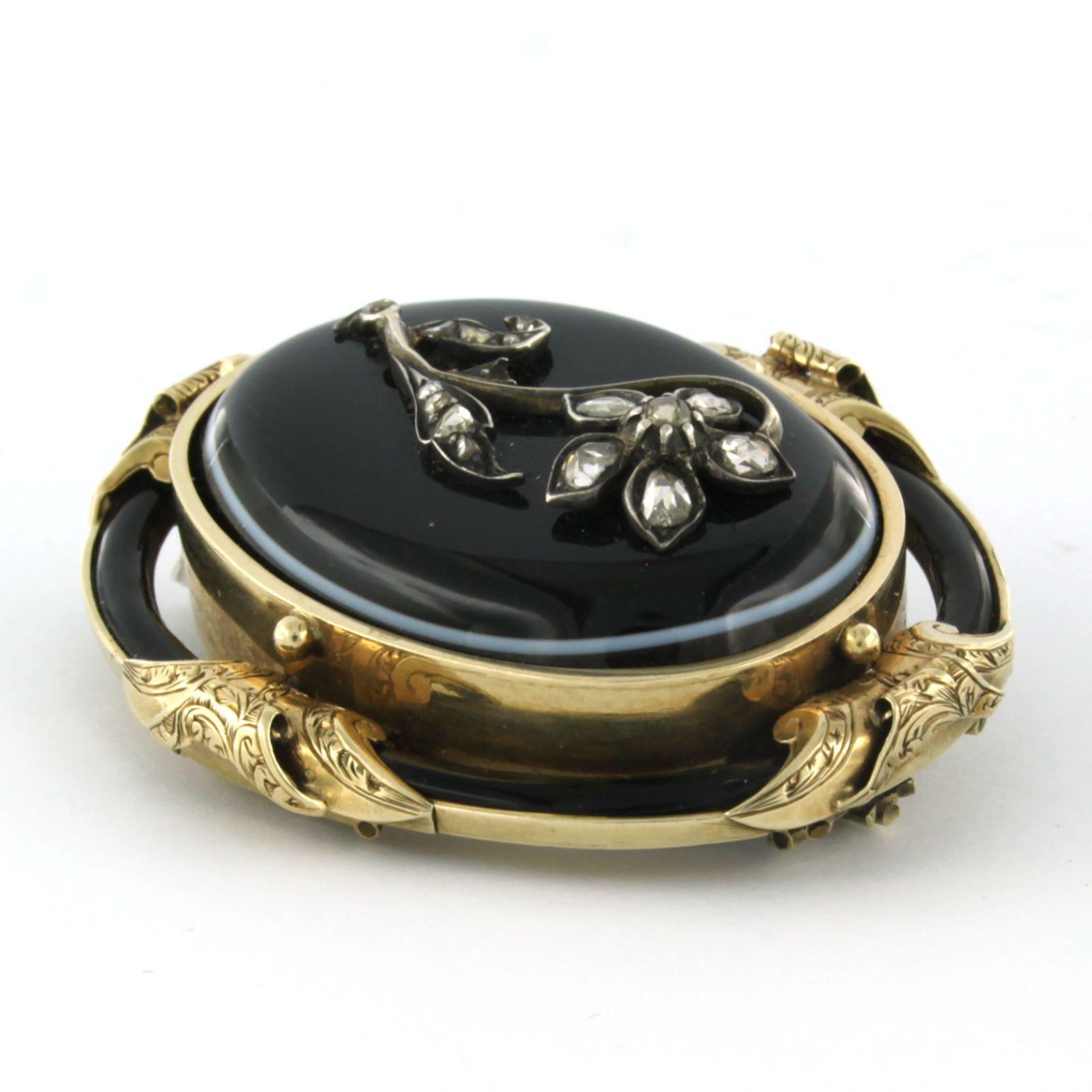 14k yellow gold with silver brooch set with onyx and rose diamonds up to 0.25ct – 41.5 grams

detailed description

the size of the brooch is 5.1 cm long by 4.4 cm wide

weight 41.5 grams

set with

- 4 x 1.7 cm x 2.5 mm oval shape cut onyx

- 1 x