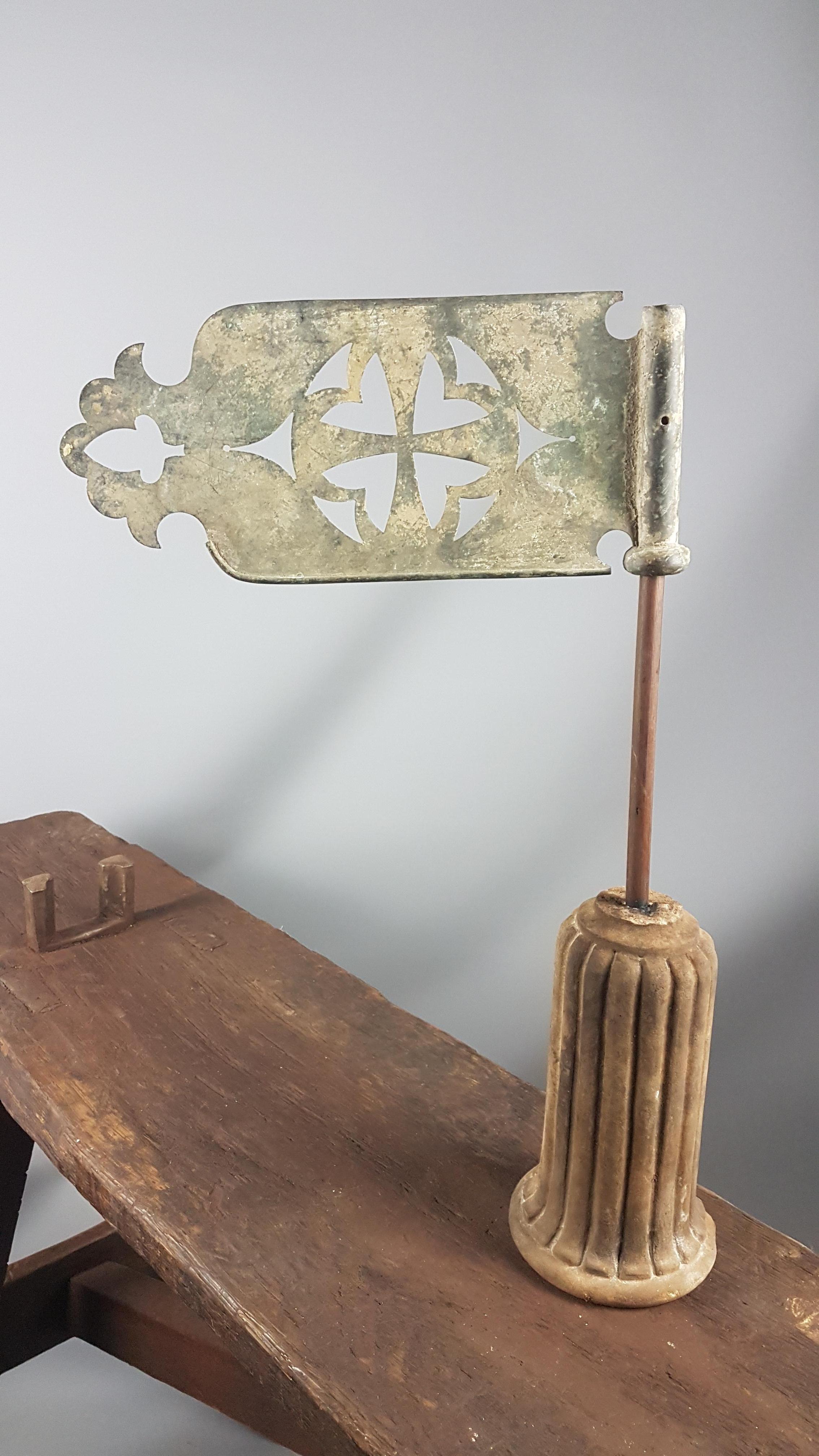 A decorative early Victorian copper banner flag weathervane often seen on the tops of Church of England churches. It has a very nice verdigris and retains elements of the original gilt finish. The form has a cross in the centre and at the tip there