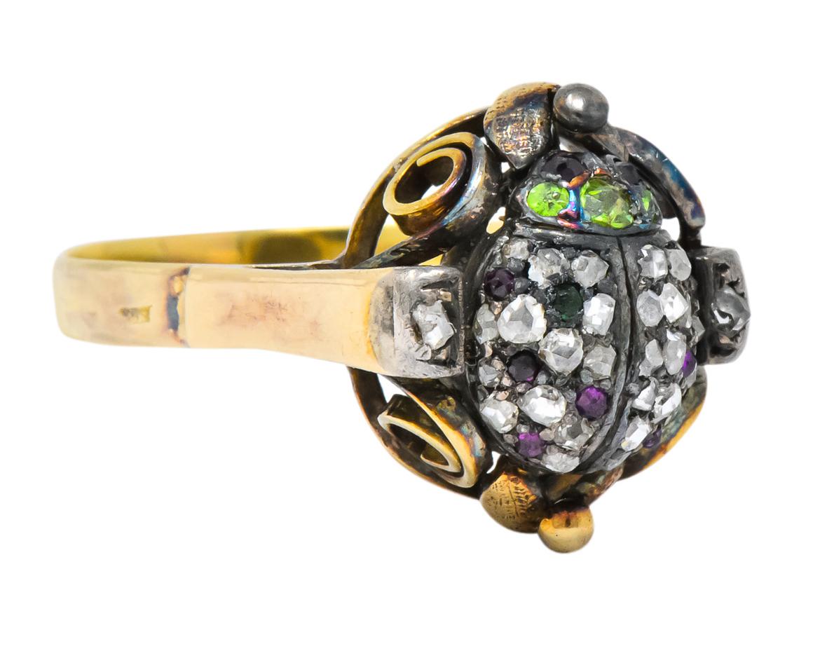 Centering a silver-topped beetle with rose cut demantoid garnets for the head and its back set throughout with rose cut diamonds

Beetle accented by rose cut rubies and flanked by two rose cut diamonds

With pierced foliate and swirl motif