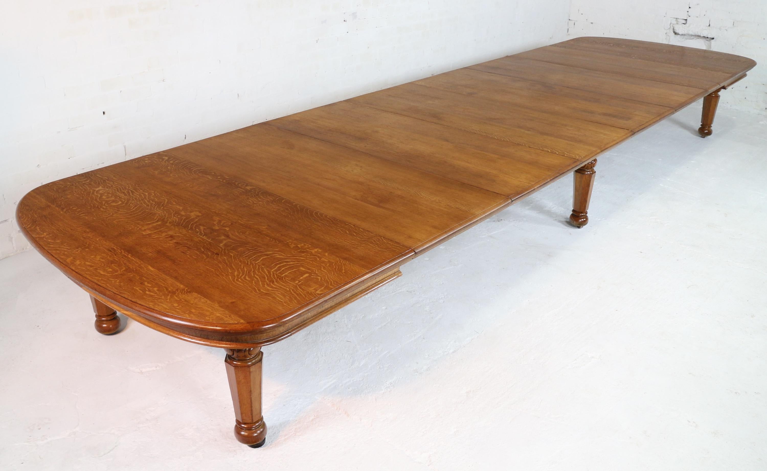 An exceptional extra wide early Victorian extending dining table in golden quarter-sawn oak and with seven leaves. Dating to circa 1840 and attributed to Gillows this unusually large 67 3/4in wide table smoothly extends from 6ft 5in to 20ft using a