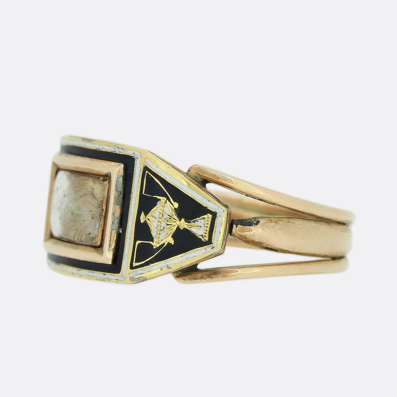 This is a wonderful 15ct yellow gold mourning ring from the Victorian era. The ring has been set with a central rectangular window that features a small locket of hair with a border of black and white enamel. Both the face of the ring and the