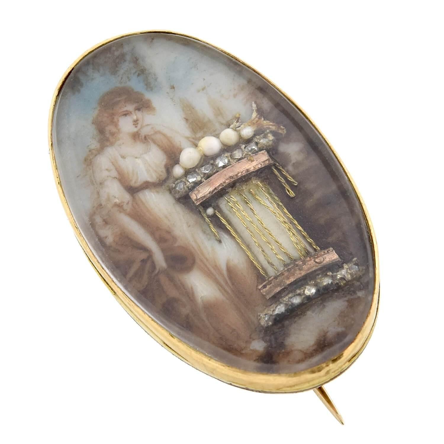 An exceptional mourning pin from the early Victorian (1850-1880s) era! Crafted in 14kt yellow gold, this beautiful piece depicts the image of a woman resting against an ornately embellished pedestal. Hand painted on porcelain, the illustration of