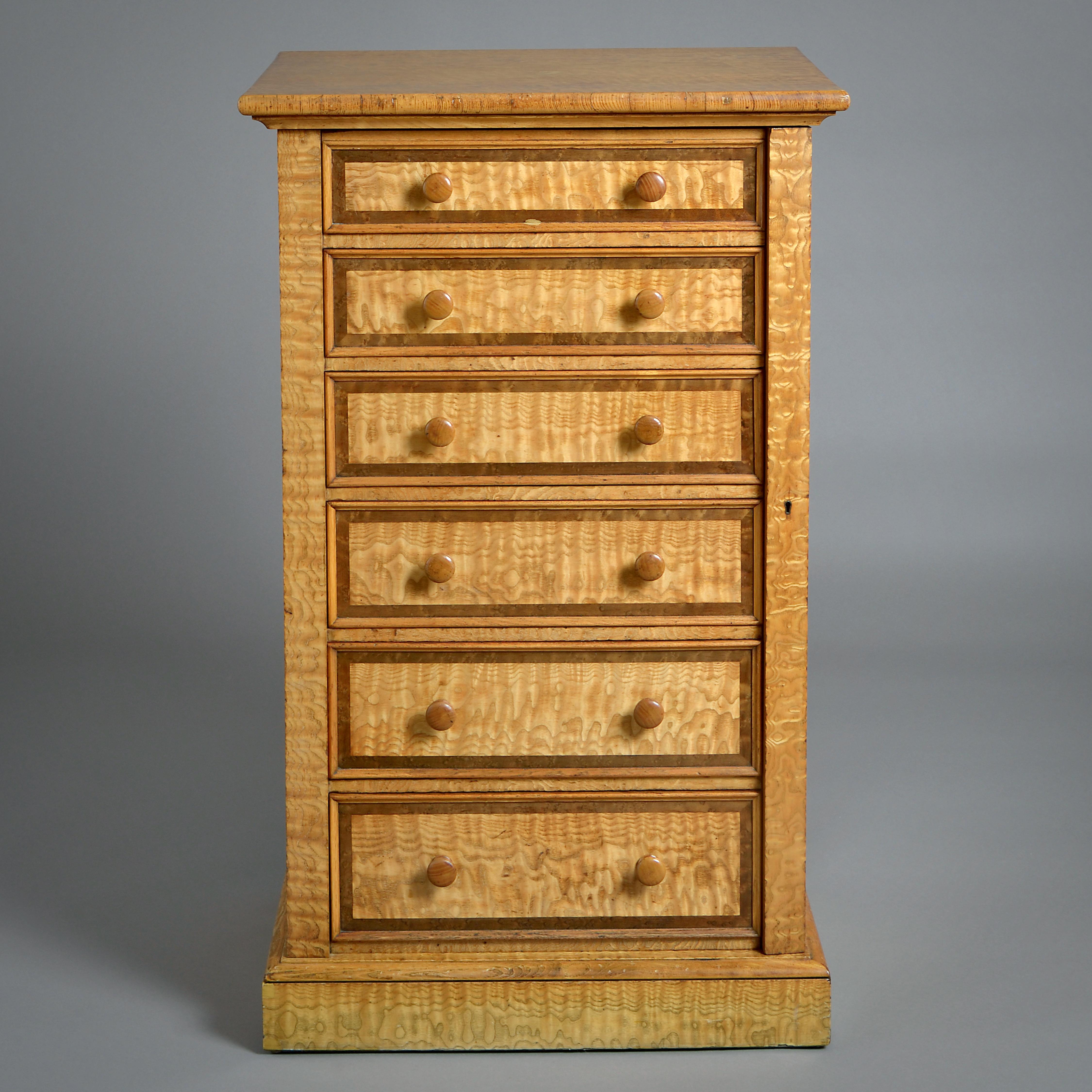 AN EARLY VICTORIAN HUNGARIAN ASH WELLINGTON CHEST ATTRIBUTED TO HOLLAND & SONS, CIRCA 1860.

With six graduated cedar and mahogany-lined drawers banded in a dark burr wood.