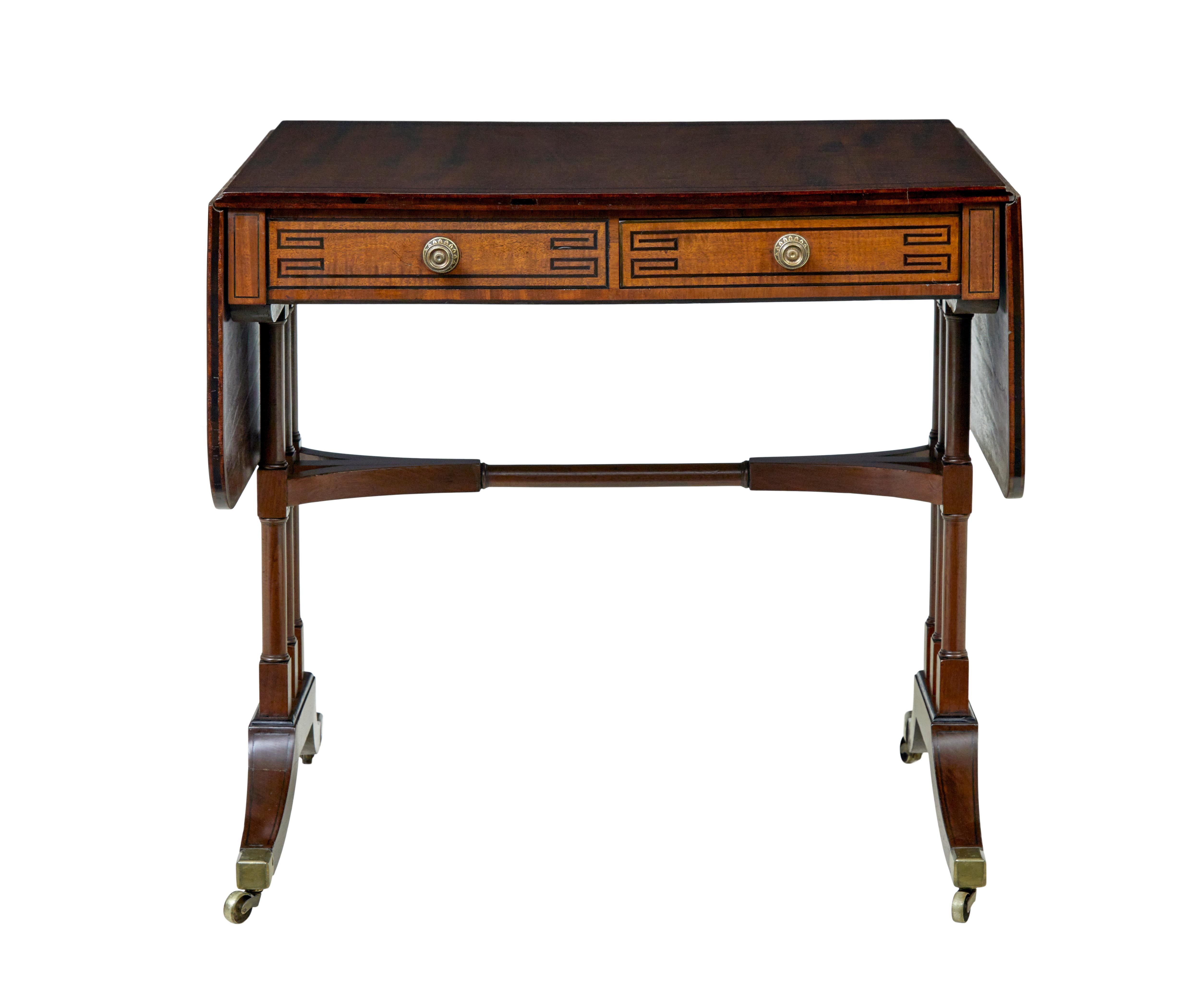 Early Victorian inlaid mahogany sofa table circa 1840.

Good quality early Victorian drop leaf sofa table, which opens to form a rectangular surface.   Surface with ebony inlaid border around the edge.  Below the top are 2 drawers, 1 each side with
