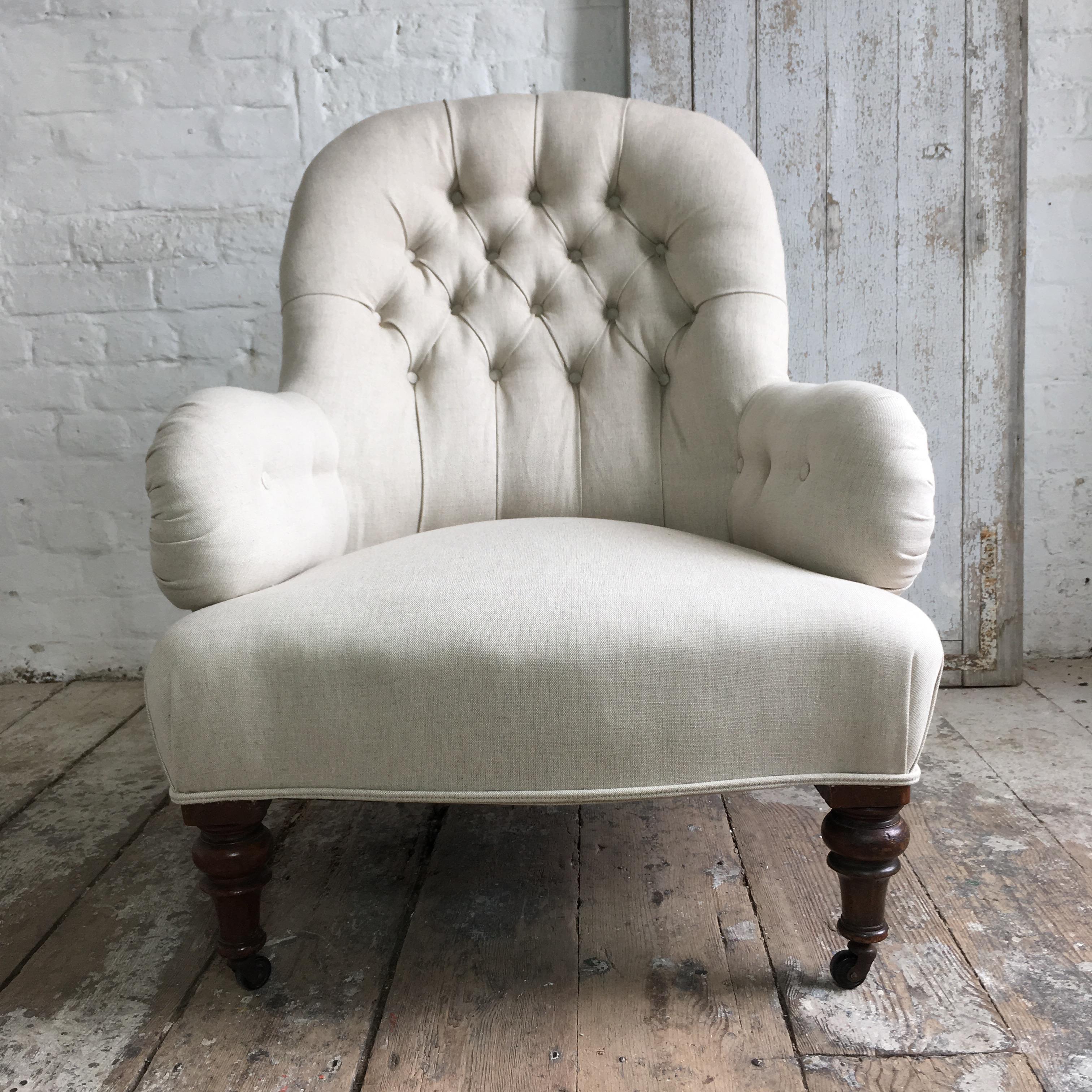 Early Victorian iron frame armchairwith button back detail. 
The chair is beautifully re-upholstered in a natural coloured linen fabric. The upholstery is brand new and completed just before listing, no use yet at all.
Turned legs at the front of