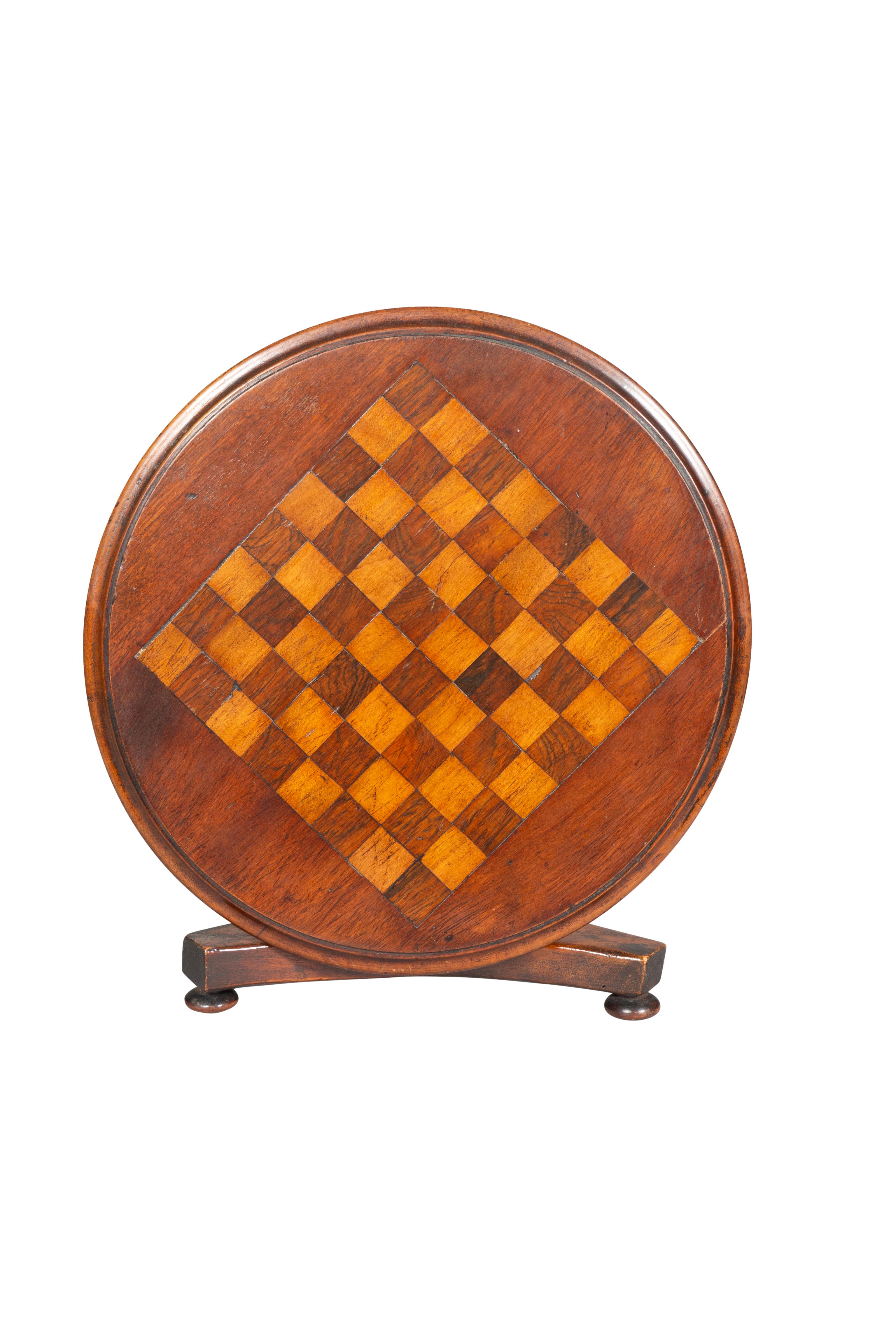 With tilt top with checkerboard inlay on a turned support and tripartite base and bun feet.