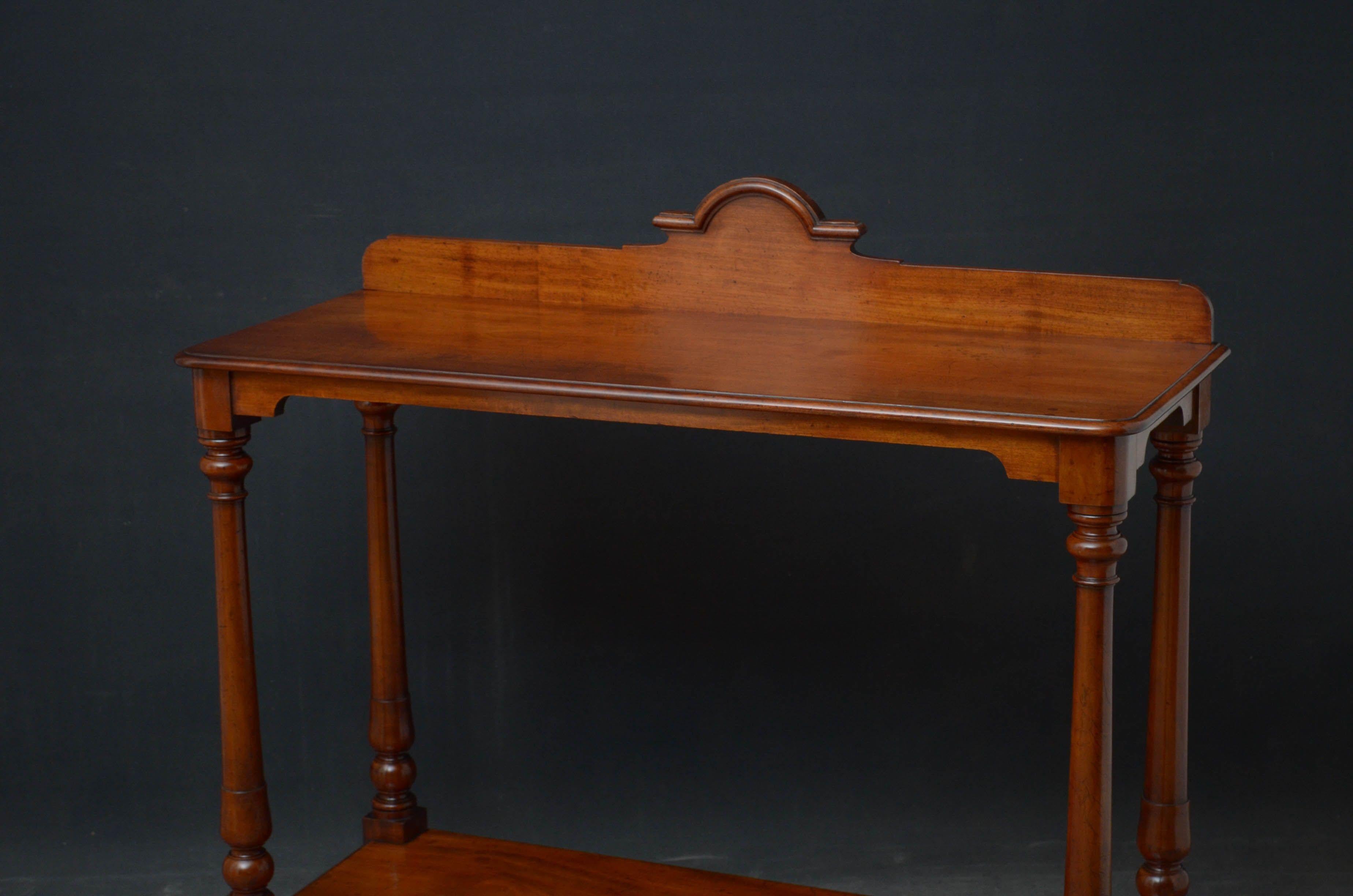 Sn5227 Early Victorian console table in mahogany, having shaped upstand to the back edge and figured top, raised on four turned legs united by undertier, all standing on bun feet. This antique hall stand / etagere retains its original finish which