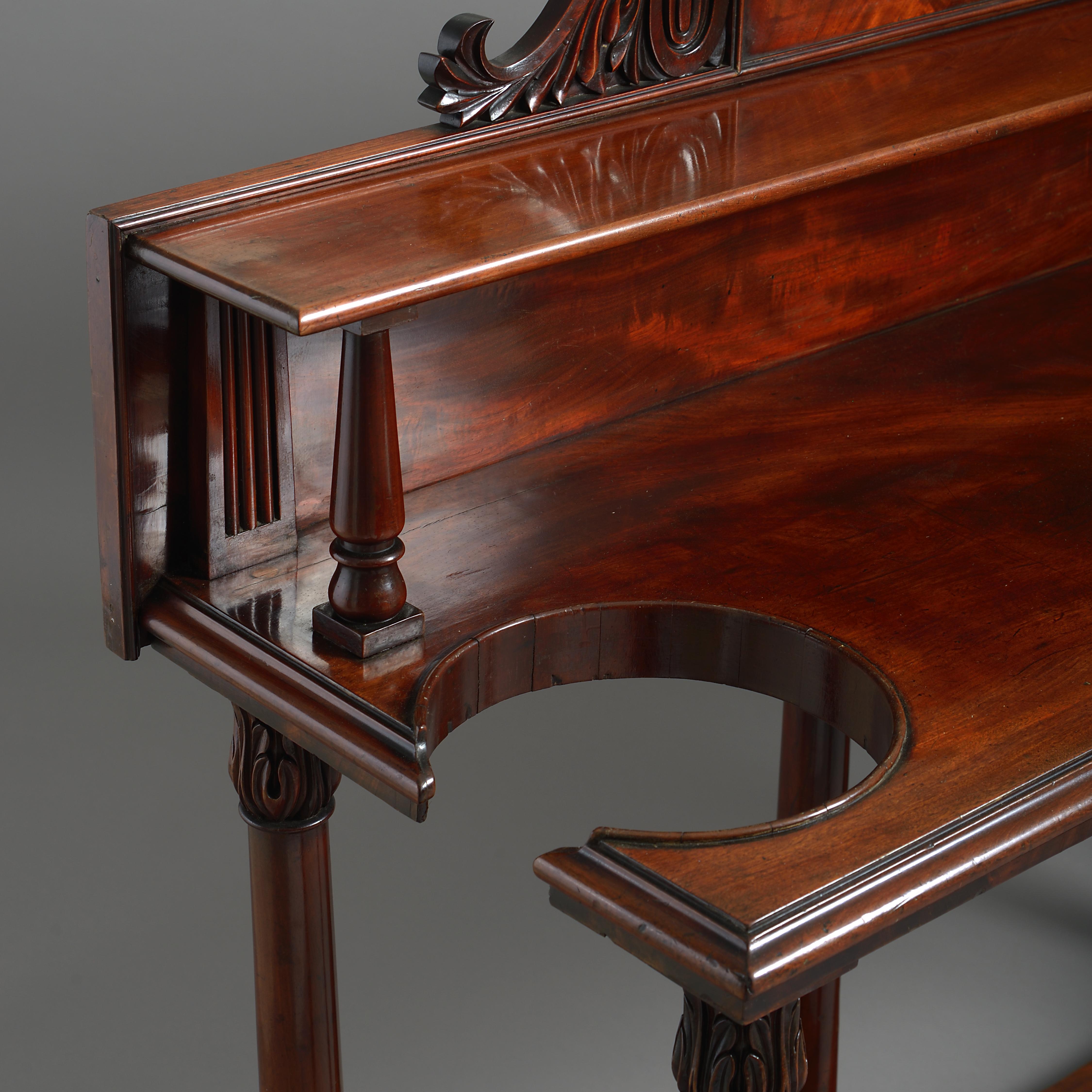 An unusual early Victorian mahogany hall-table, with apertures for sticks and a central frieze drawer, circa 1840.