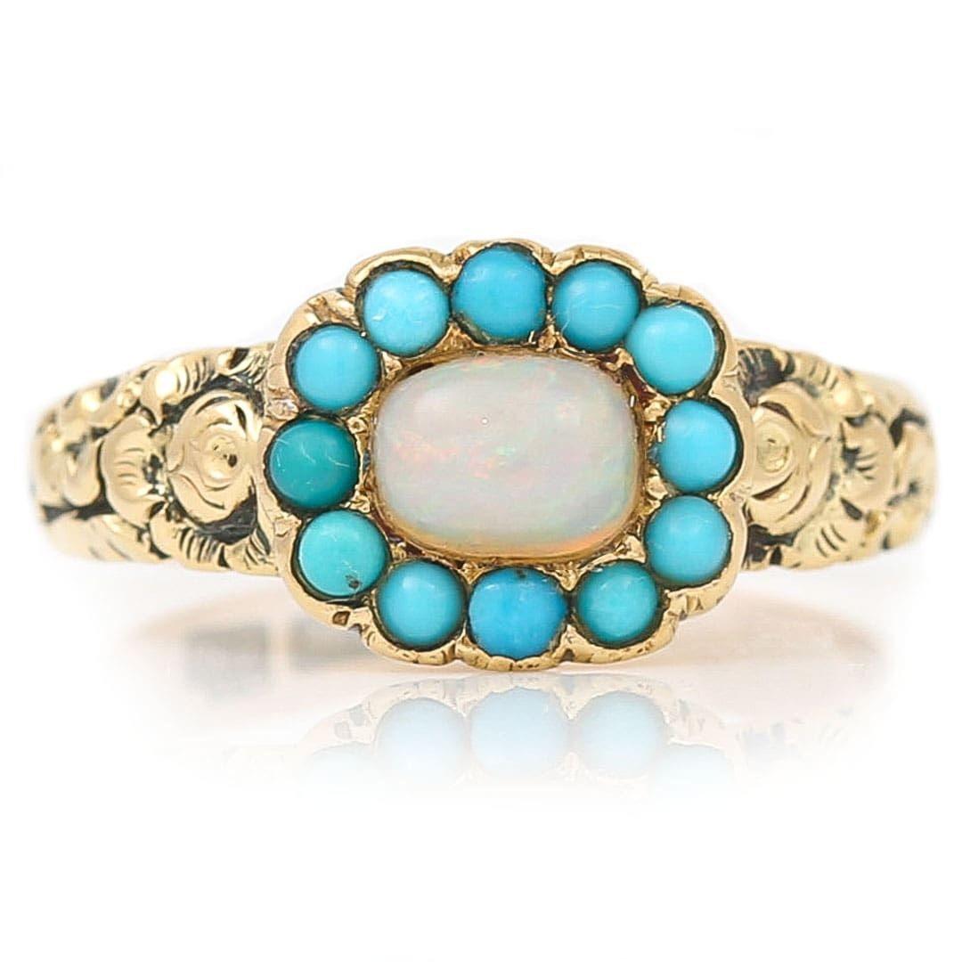A unique and pretty early Victorian 9ct gold precious opal and turquoise plaque ring, hand crafted in circa 1840. Rings of the period often had heavily decorated shanks with deep chasing and engravings depicting floral scenes and foliate motifs,