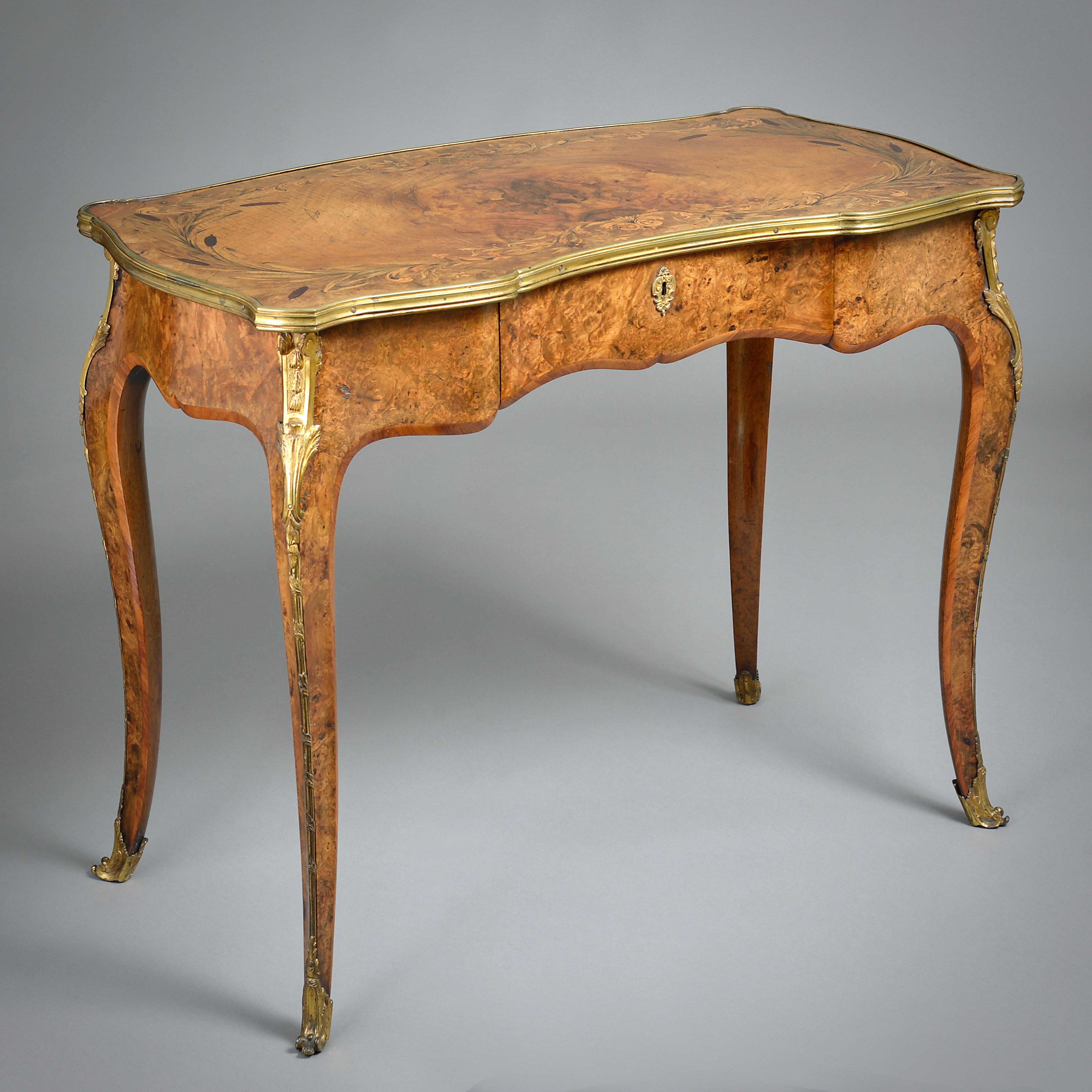 A FINE EARLY VICTORIAN ORMOLU-MOUNTED BURR-WALNUT AND MARQUETRY WRITING-TABLE, CIRCA 1850.

The shaped top inlaid with bulrushes above a single frieze drawer.
