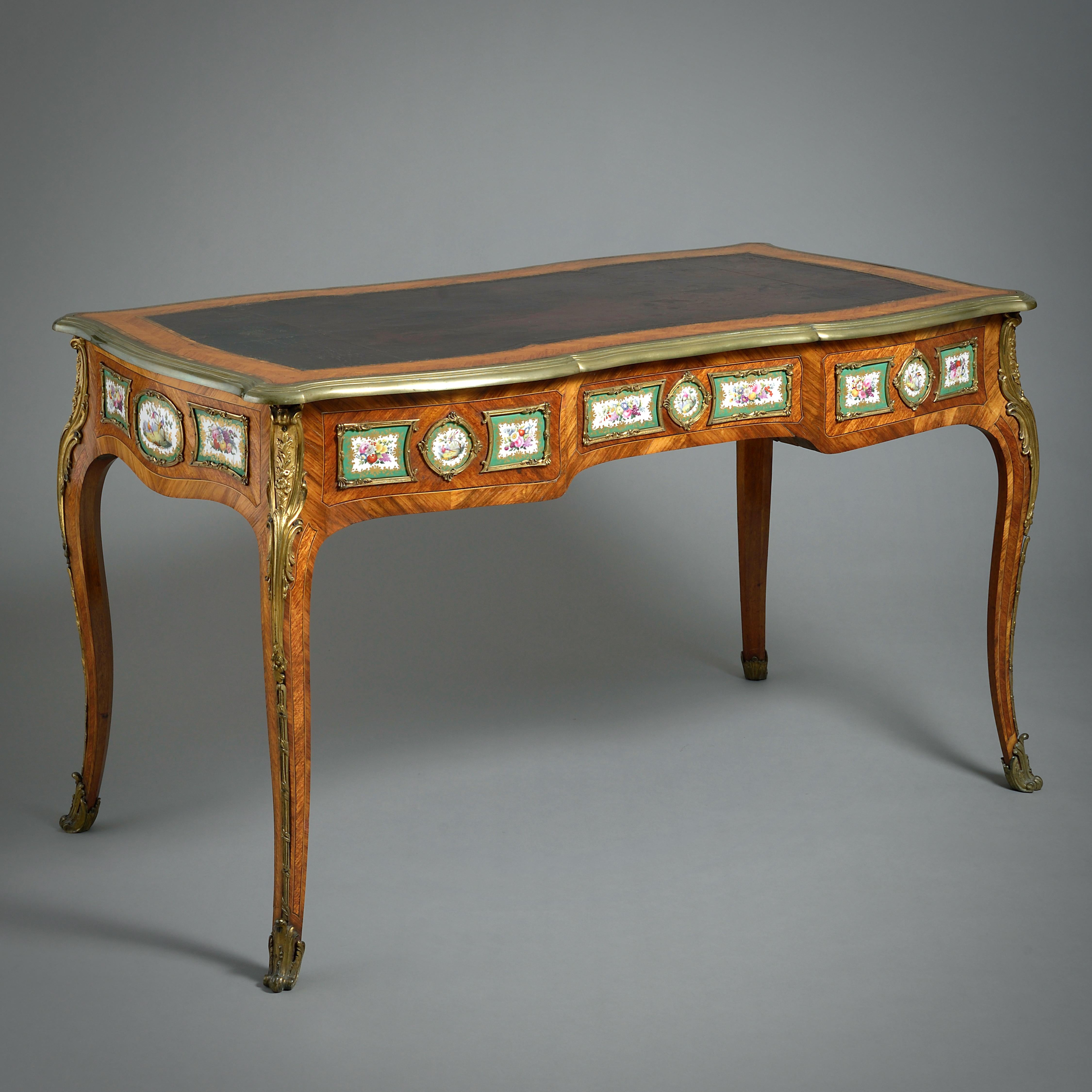 A FINE EARLY VICTORIAN PORCELAIN AND ORMOLU-MOUNTED KINGWOOD BUREAU-PLAT ATTRIBUTED TO EDWARD HOLMES BALDOCK, CIRCA 1840.

The top inset with its original maroon leather. The frieze with three sprung drawers.