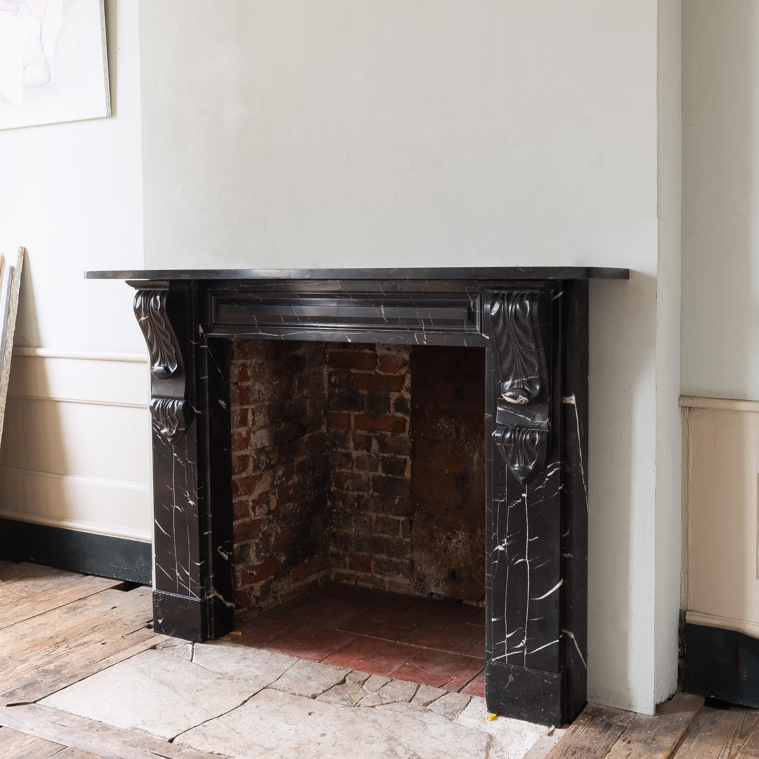An early Victorian Radford Black fireplace, the plain shelf and panelled frieze supported by jambs with unusual double corbels, on block feet.
After some investigation it was discovered that the material used for this fireplace is a seldom seen