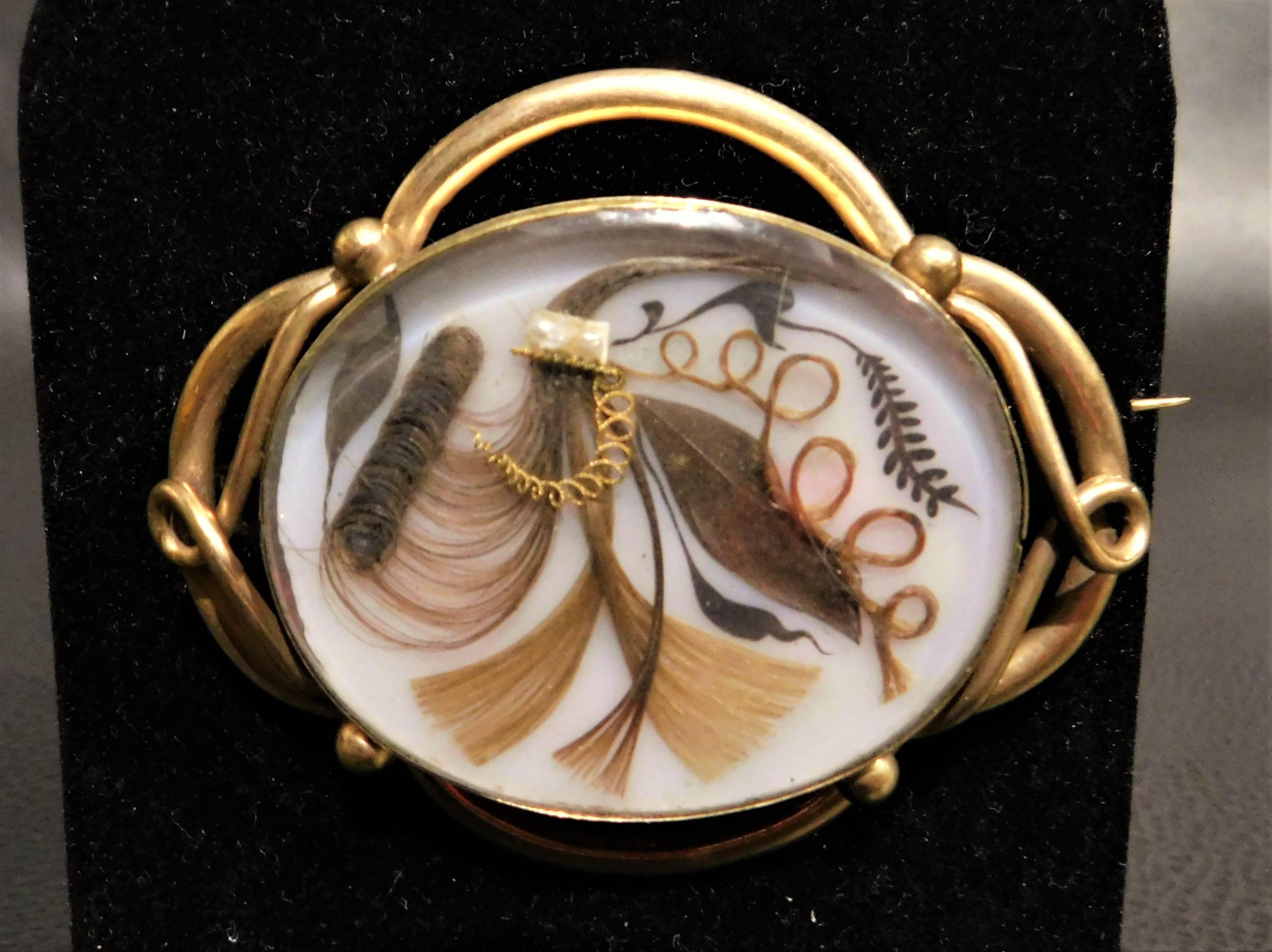 Beautiful ornate circa 1840 Victorian mourning hair pin brooch, pendant. Oval under glass, gold-plated in excellent condition.