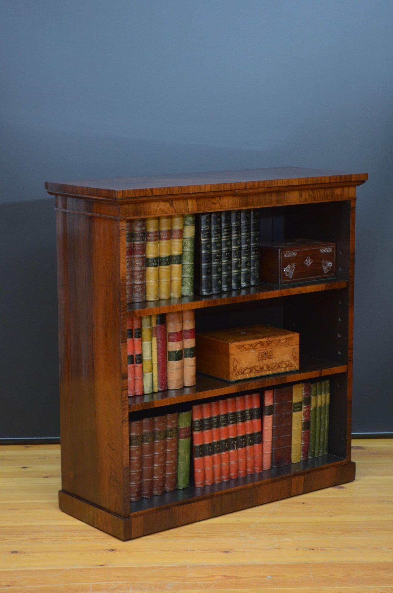 Sn5293 Fine quality, simple and elegant early Victorian open bookcase in rosewood, having well figured top above shallow frieze and two height adjustable shelves, all standing on plinth base. This antique bookcase has been sympathetically restored