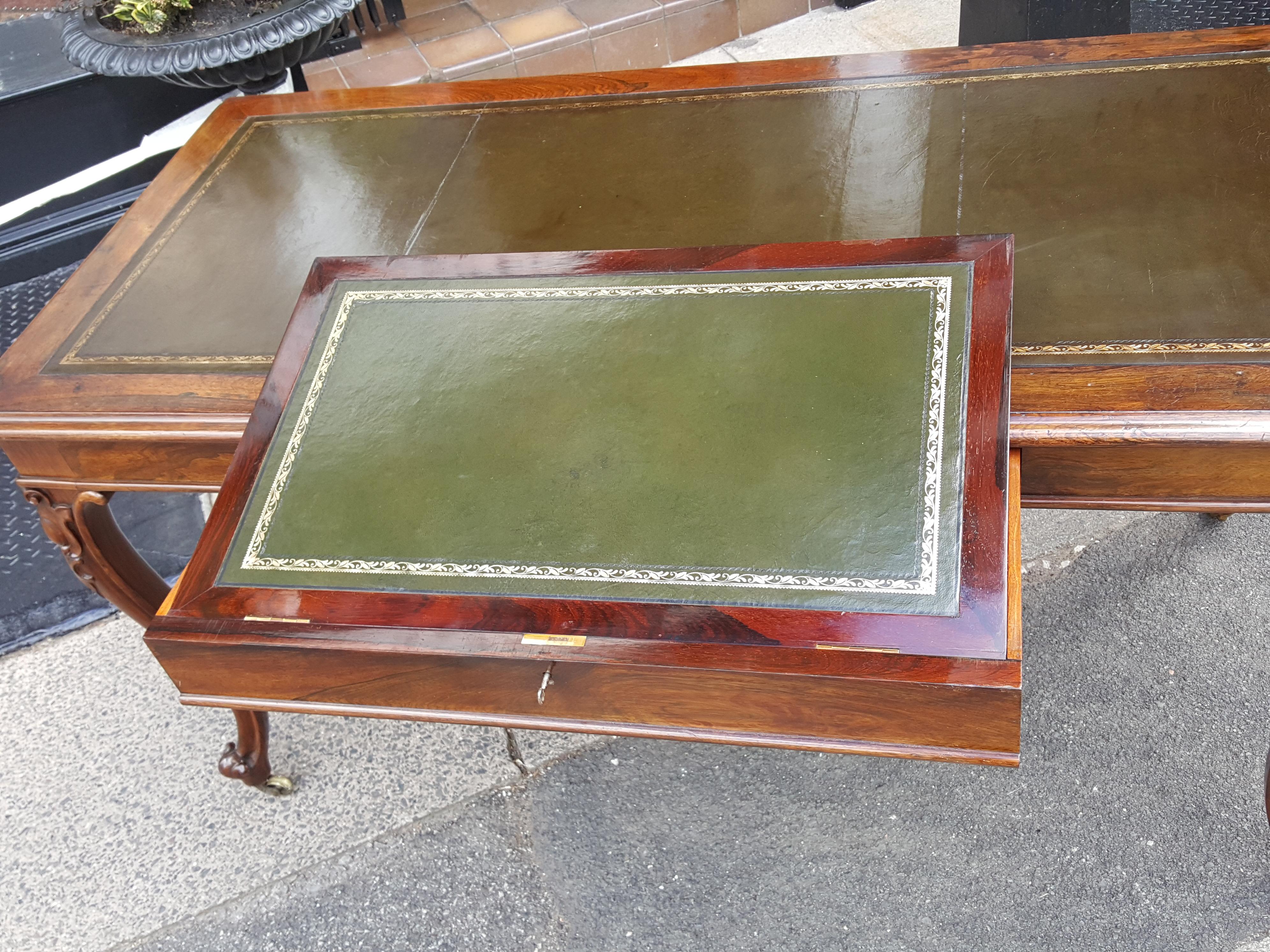 Early victorian rosewood writing table desk with embossed and tooled leather insert, drawer containing writing slope on cabriole legs and brass castors 55