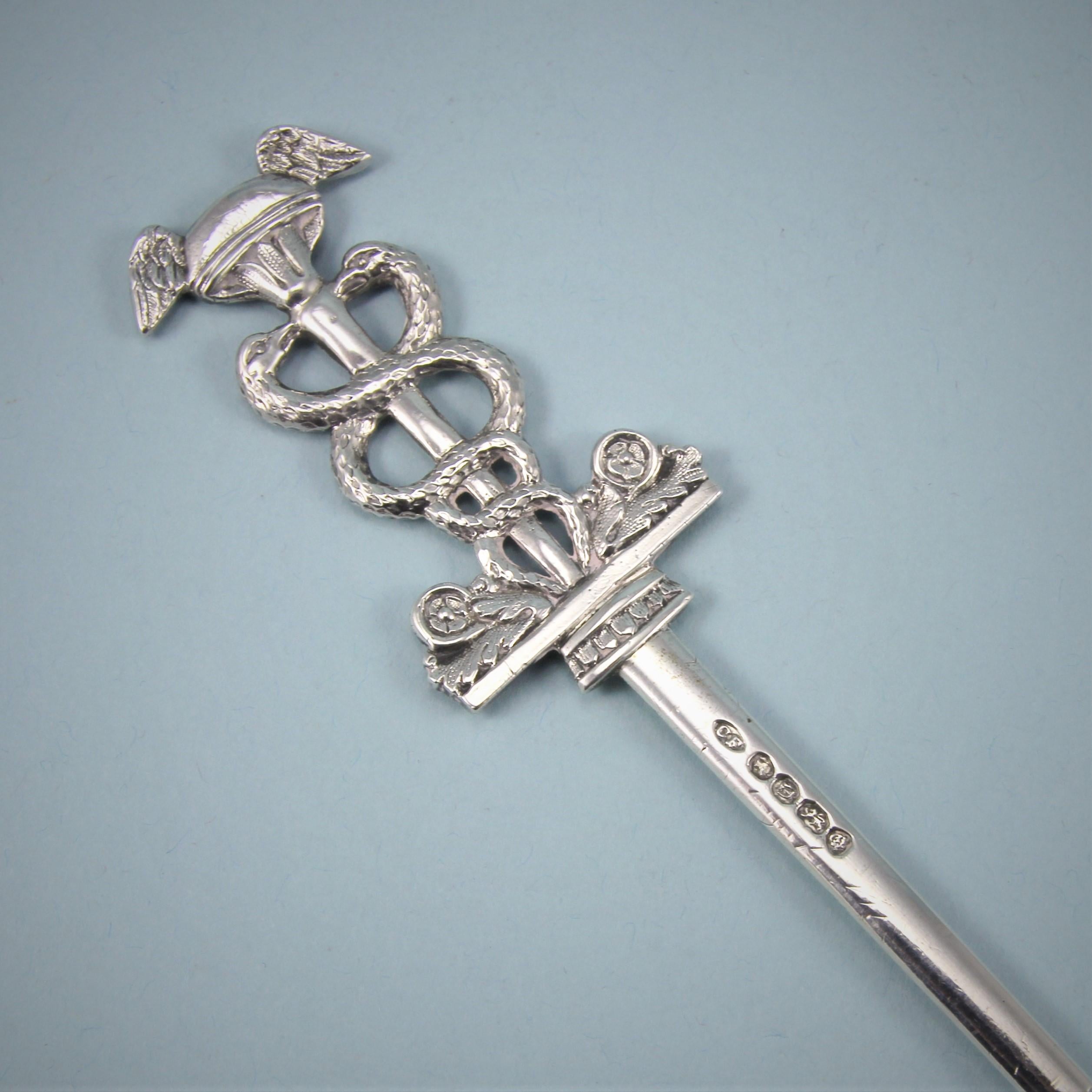 Intriguing Early Victorian sterling silver skewer. 
Maker: Charles Fox II. London 1839. 

This unusual silver skewer is formed as a Caduceus, an ancient symbol and staff of authority. It is particularly noted for having been carried by Hermes the