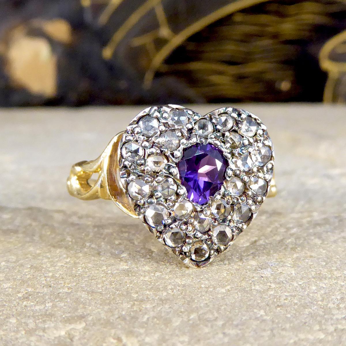 This lovely contemporary ring has been crafted to resemble and be disguised as an Early Victorian ring. Featuring in this ring is a 0.28ct Pear Cut Amethyst showing a bright and vibrant purple colour surrounded by a double cluster of Rose Cut