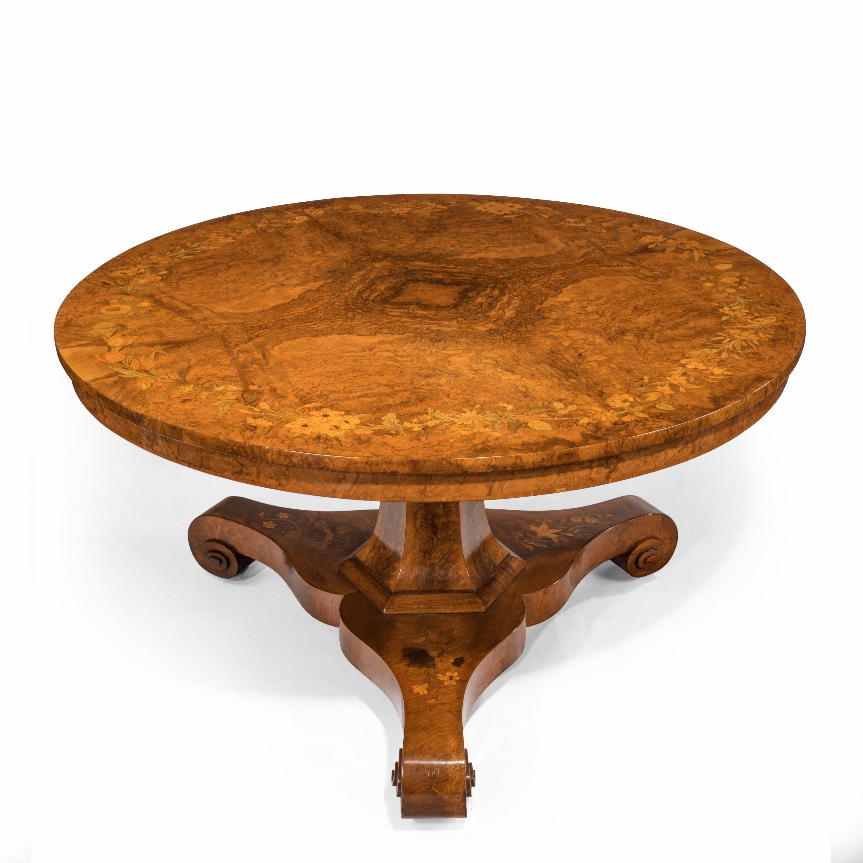An early Victorian walnut marquetry centre table, attributed to Edward Holmes Baldock, of circular form with a superb quarter veneered burr walnut top inlaid with a garland of naturalistic British flowers in stained boxwoods, all on a flared