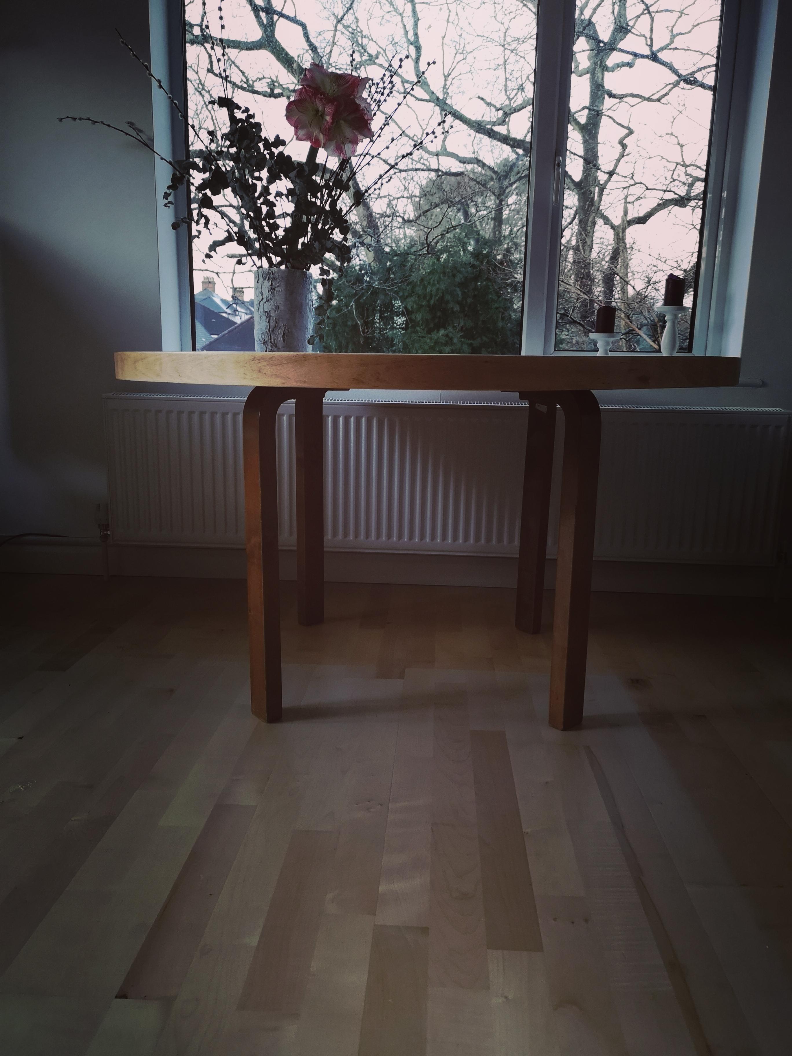 A sunning early vintage Alvar Aalto dining table 91, circa 1940s. The tabletop is dark wood veneer, with lighter color wood band on the edge. The original lacquer was peeling off, so the tabletop has just been professionally restored, stripped down
