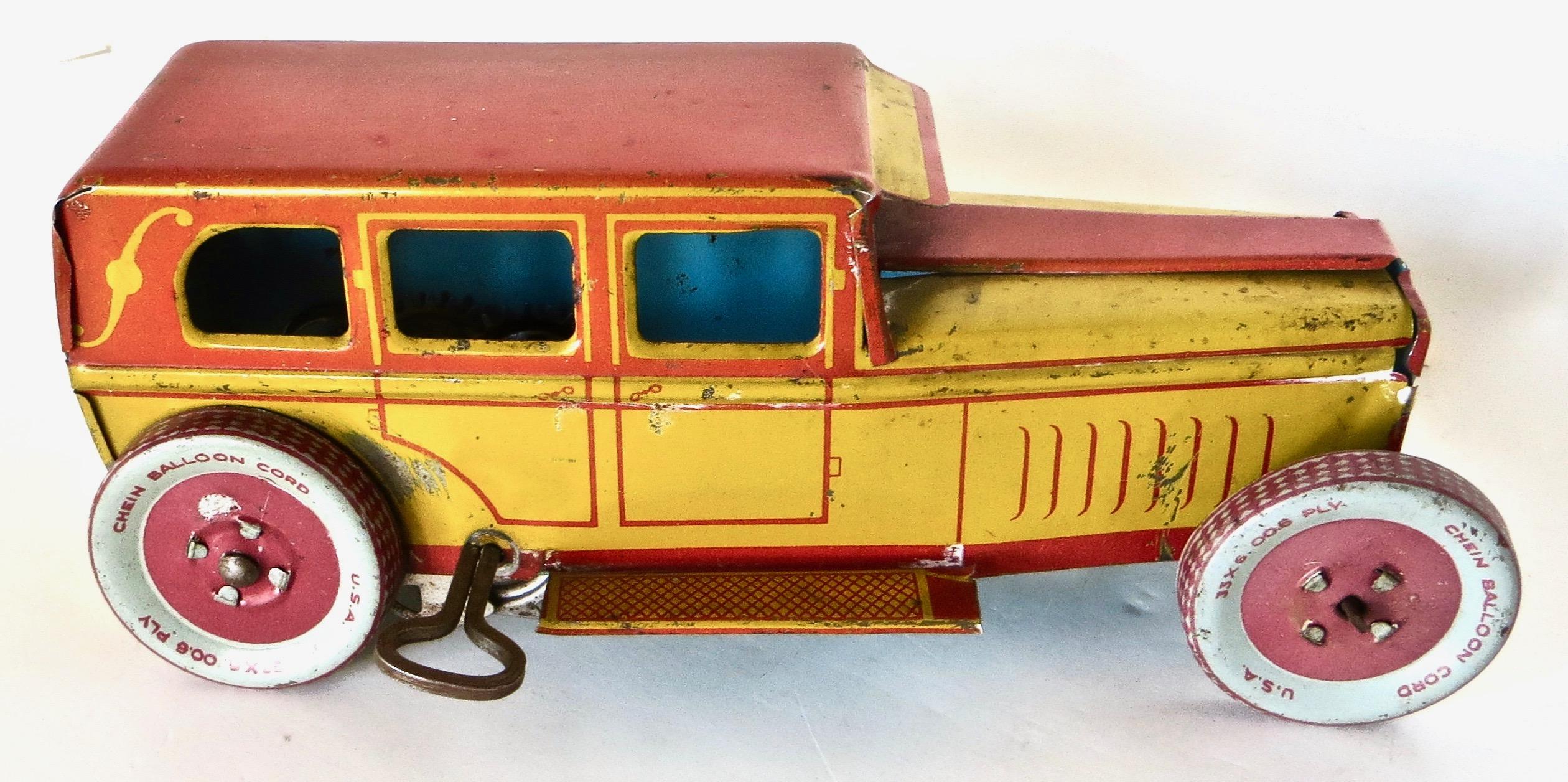 This is one of the earlier, New York City based, J. Chein Company, tin toy pieces. They started doing lithography in 1930.
This toy wind-up sedan was made circa 1930 and is brightly lithographed and painted in red and yellow, with grey and red