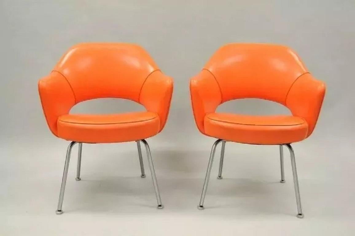 Early Vintage Eero Saarinen for Knoll Orange Vinyl Executive Arm Chairs - a Pair. Item features very comfortable form, classic Mid-Century design and early original Knoll label. Circa Mid 20th Century. Measurements: 32