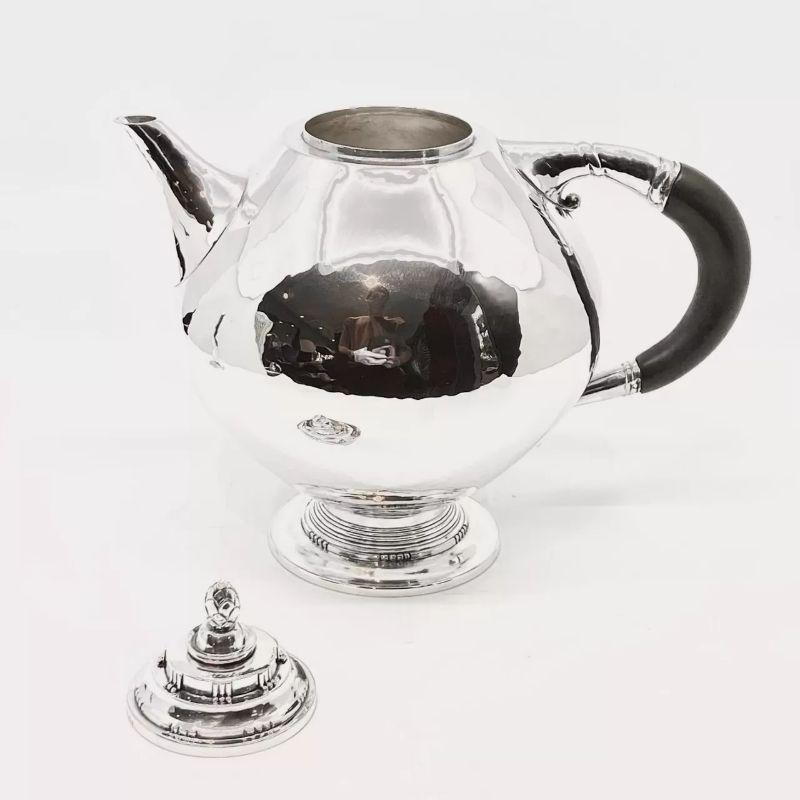 An antique Georg Jensen 830 silver teapot with ebony handle, design #279 by Johan Rohde from circa 1918.

Additional information:
Material: Silver
Styles: Art Nouveau
Hallmarks: Vintage Georg Jensen 1915-1927 hallmarks and date stamp