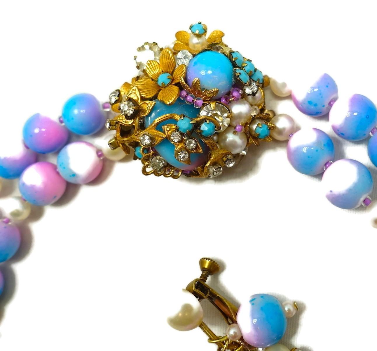 This vintage early Miriam Haskell set has pink and blue glass beads with faux pearls and crystal rhondells in a gold tone setting.  In excellent condition, the necklace measures 18-1/2” long. Each bead is 5/16” wide. The slide in clasp has a round
